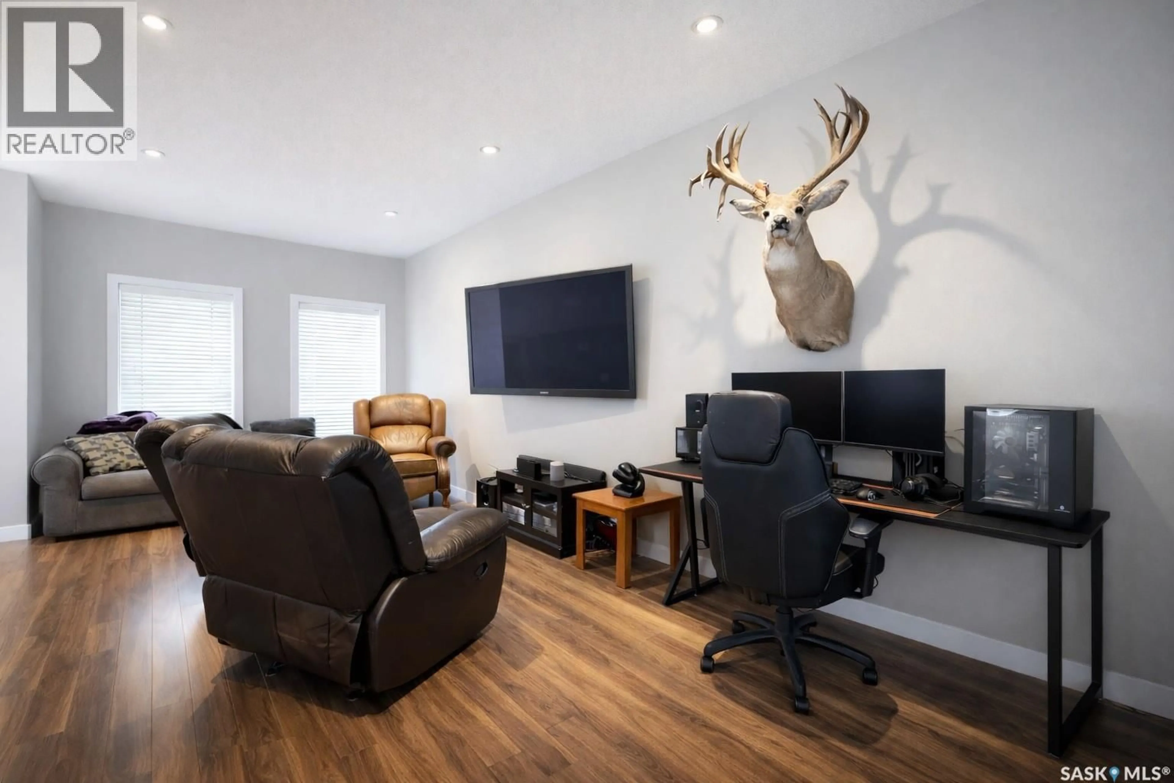 Living room with furniture, wood/laminate floor for 1026 EVERGREEN BOULEVARD, Saskatoon Saskatchewan S7W0V9