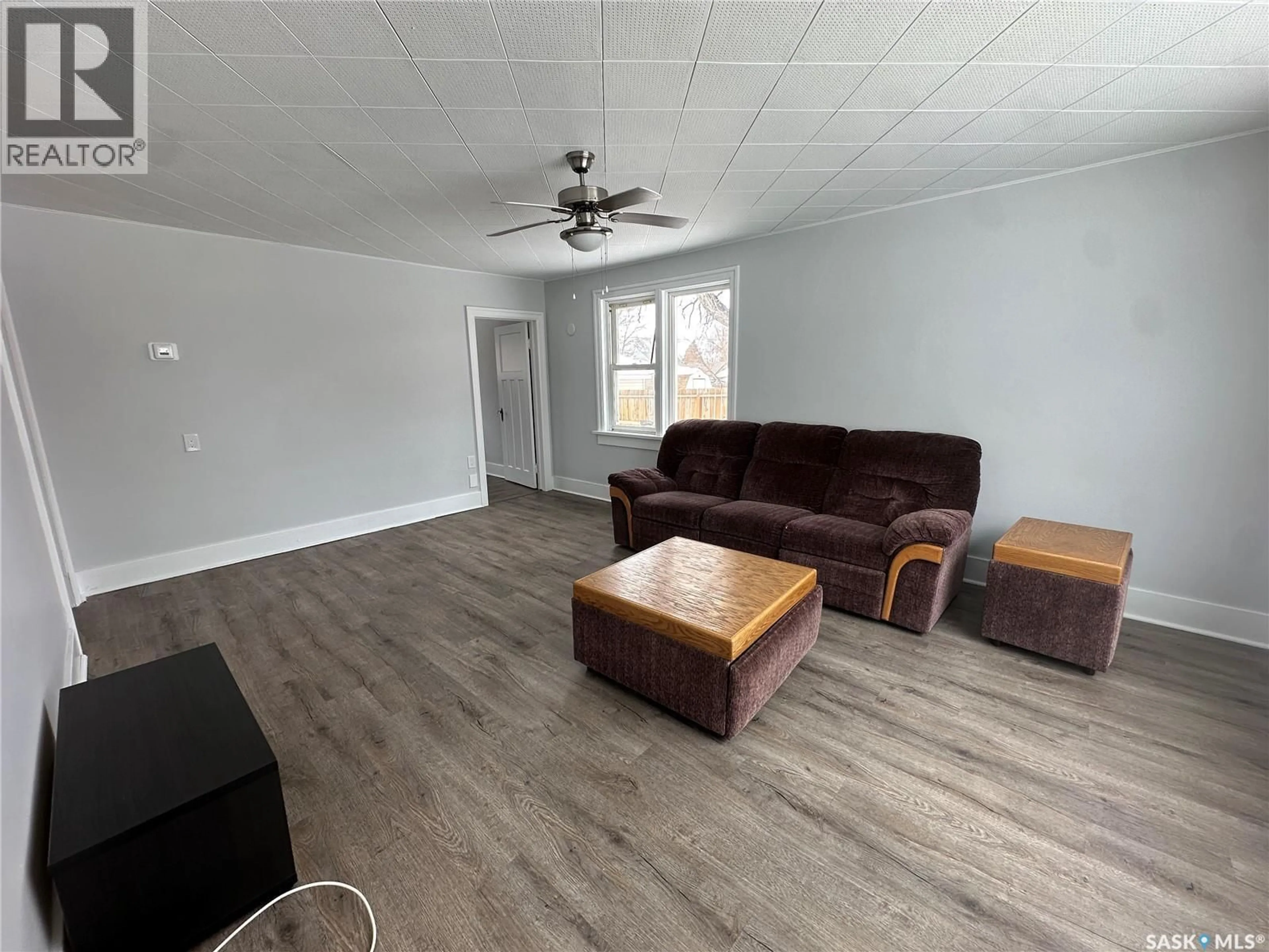 Living room with furniture, wood/laminate floor for 154 MAXWELL STREET, Kamsack Saskatchewan S0A1S0