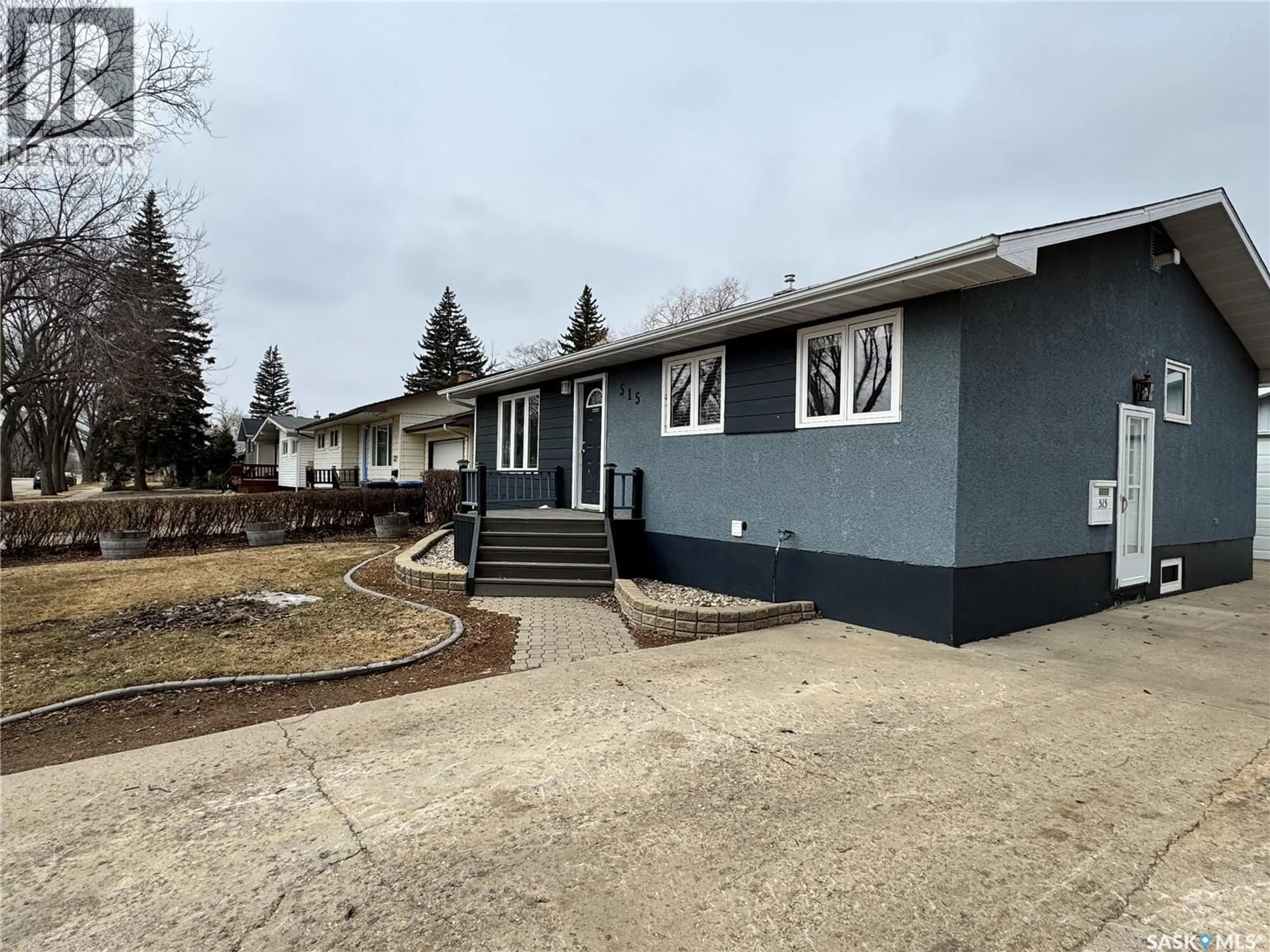 Home with vinyl exterior material, street for 515 3RD AVENUE, Weyburn Saskatchewan S4H1R2