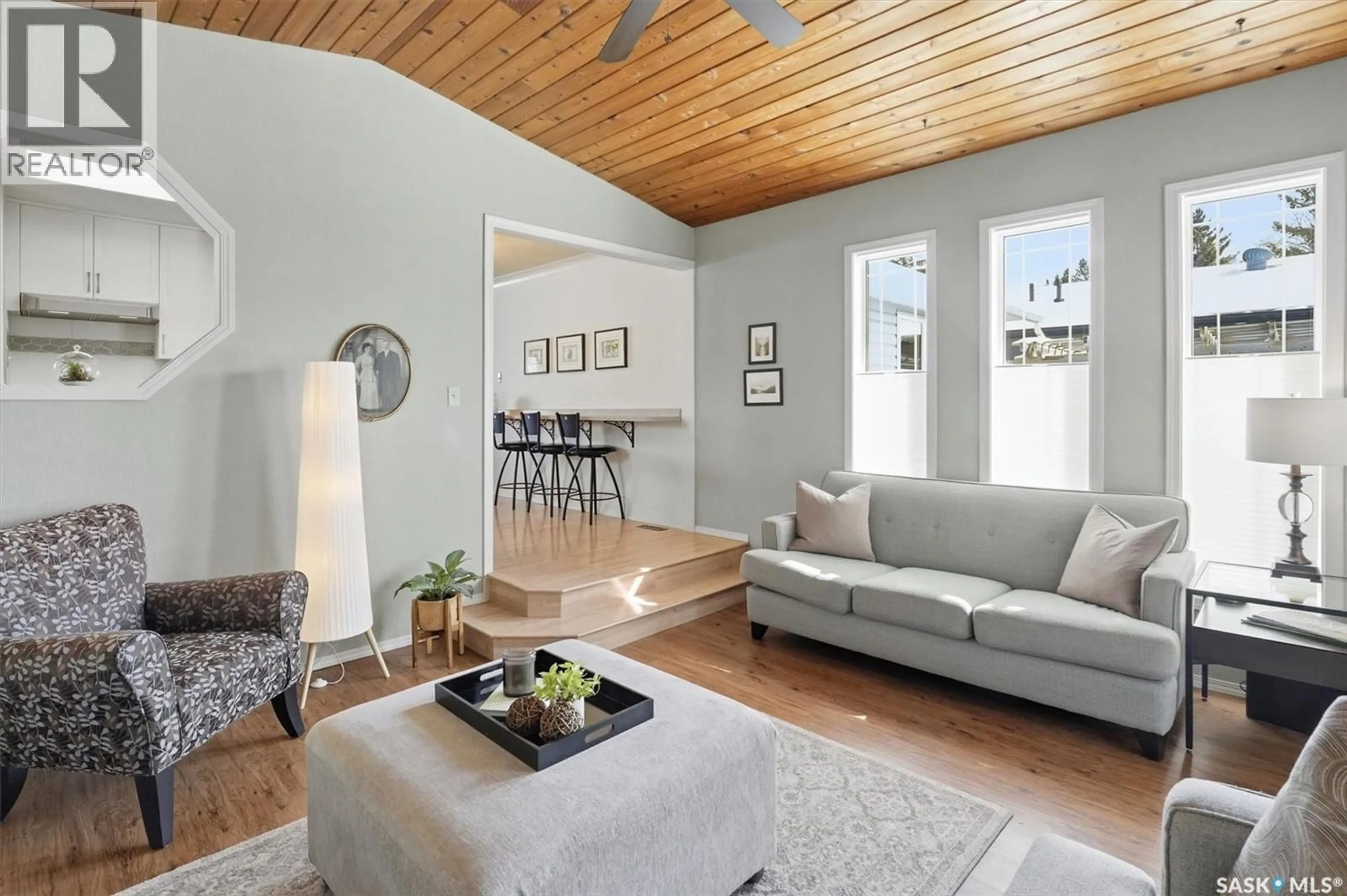 Living room with furniture, wood/laminate floor for 106 LAURENTIAN DRIVE, Saskatoon Saskatchewan S7H4M2