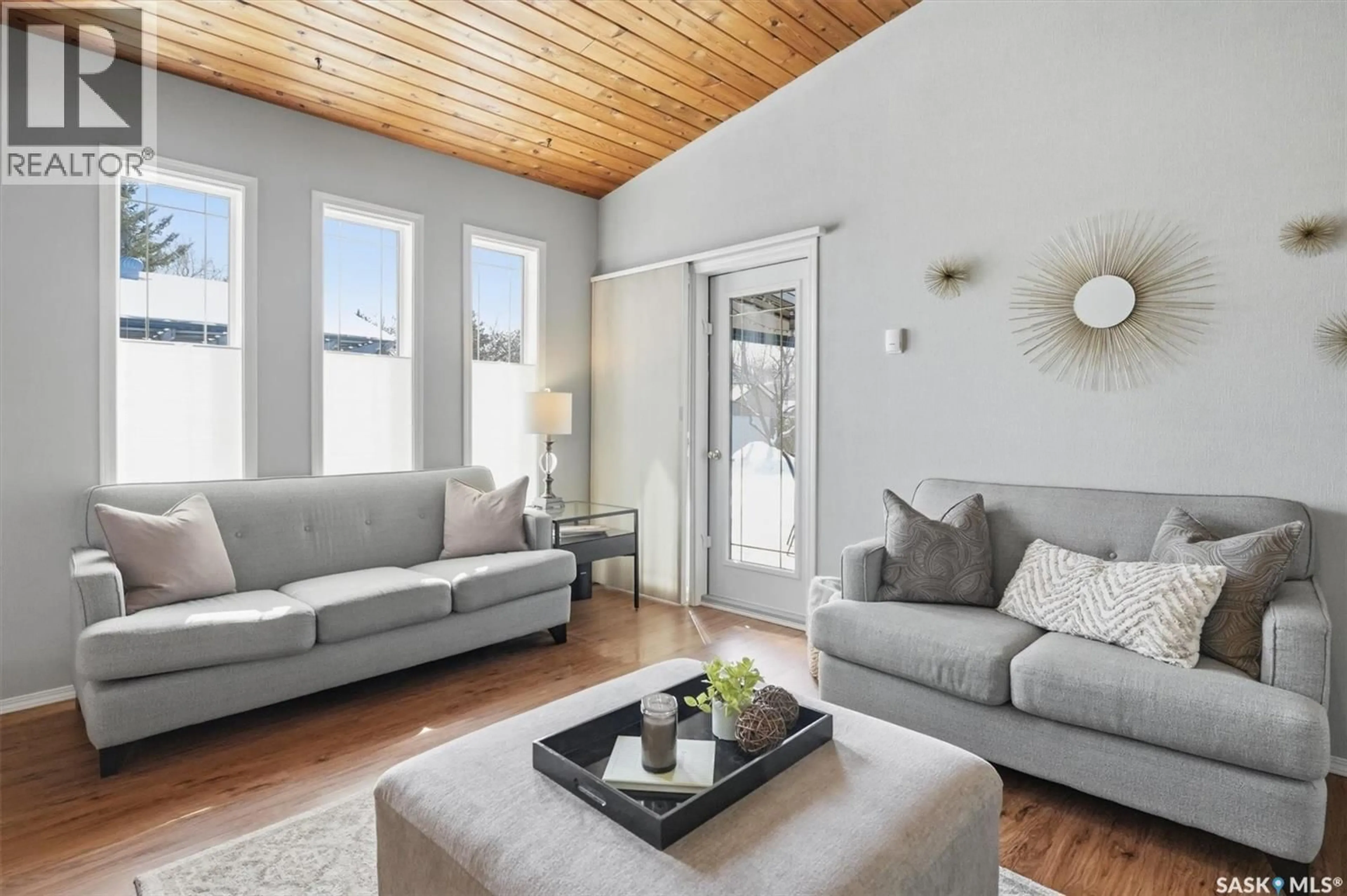 Living room with furniture, wood/laminate floor for 106 LAURENTIAN DRIVE, Saskatoon Saskatchewan S7H4M2