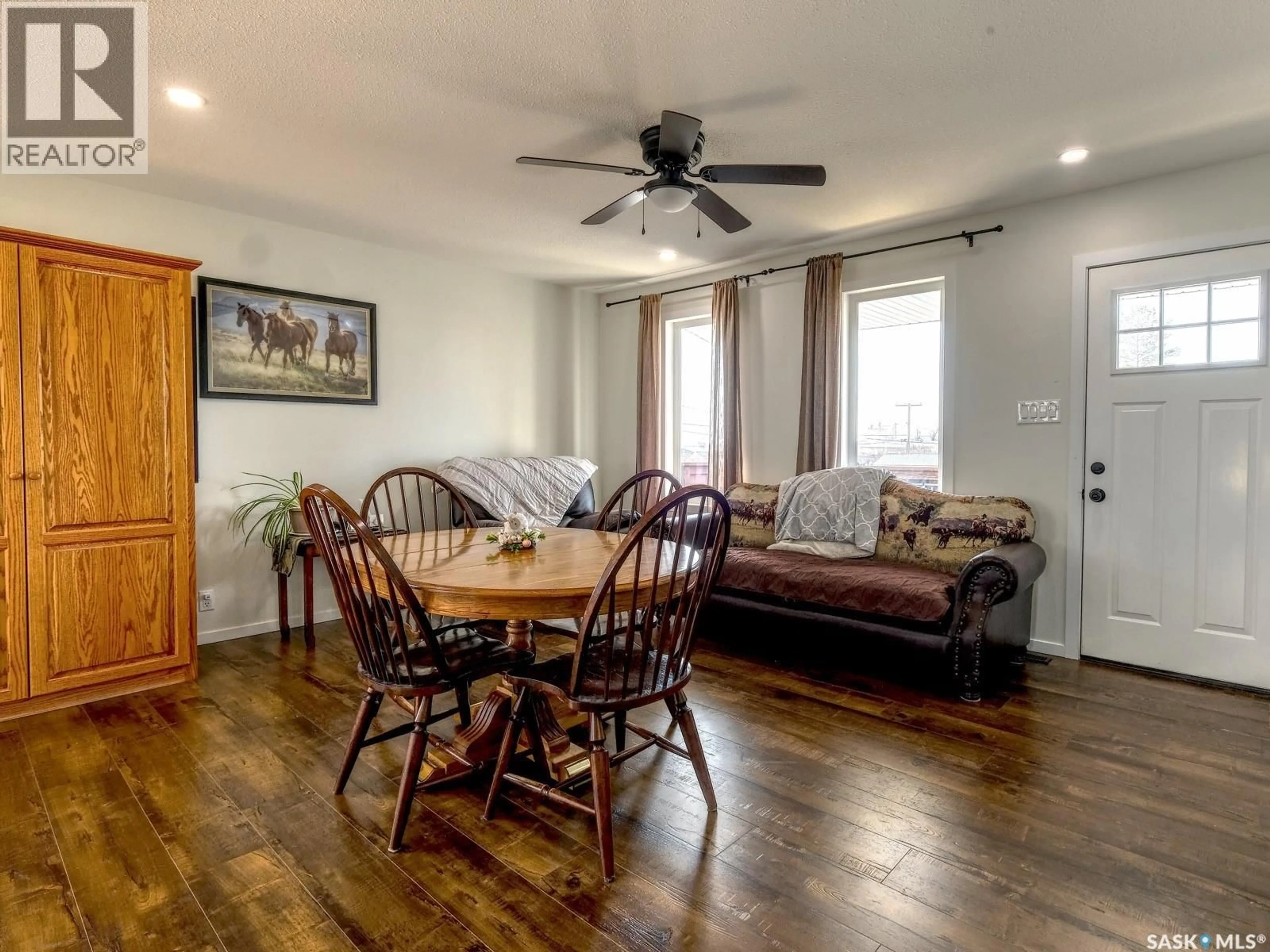 Living room with furniture, wood/laminate floor for 304 2ND AVE, Biggar Saskatchewan S0K0M0