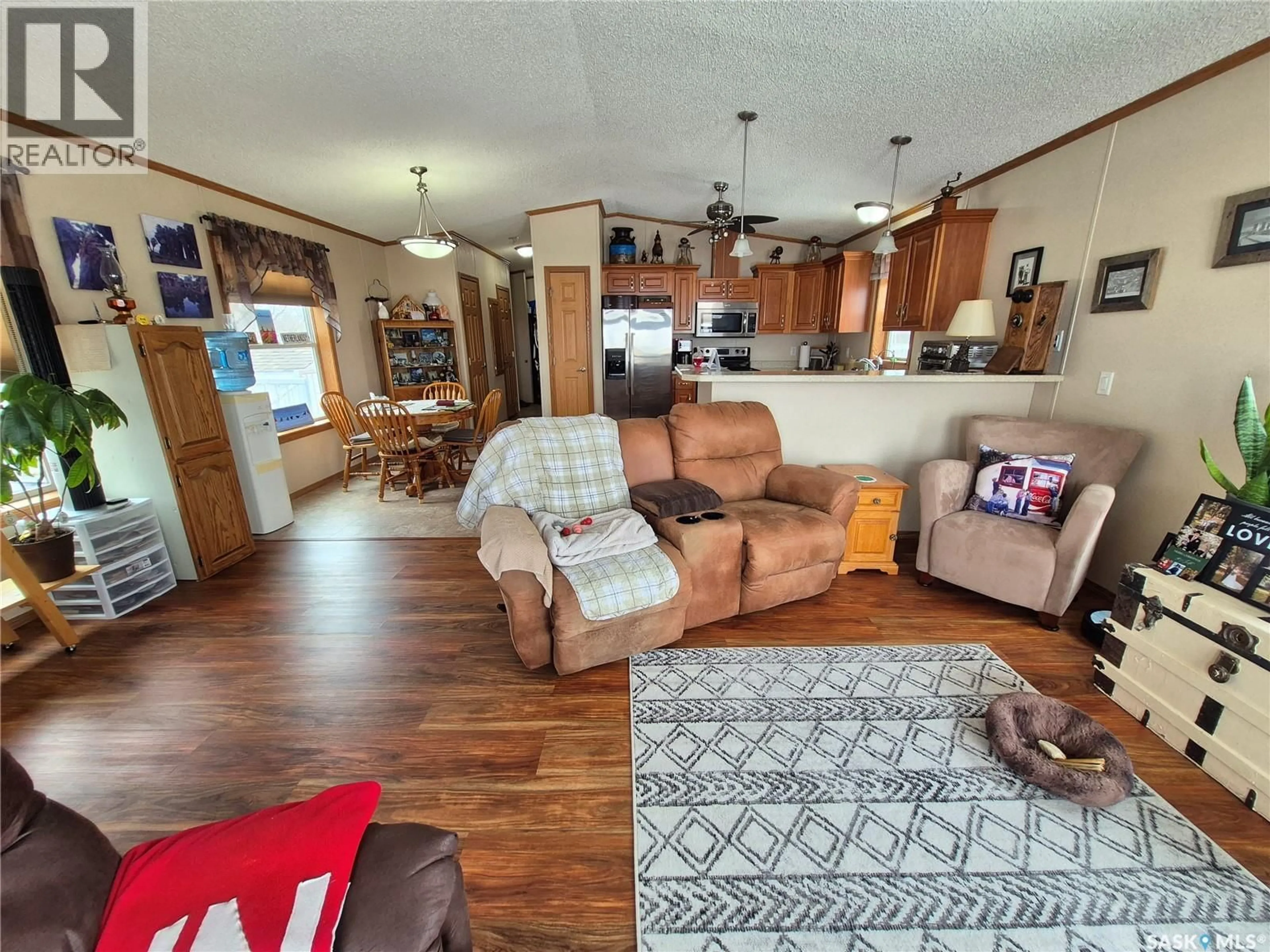Living room with furniture, wood/laminate floor for 4425 ACCESS ROAD, Halbrite Saskatchewan S0C1H0