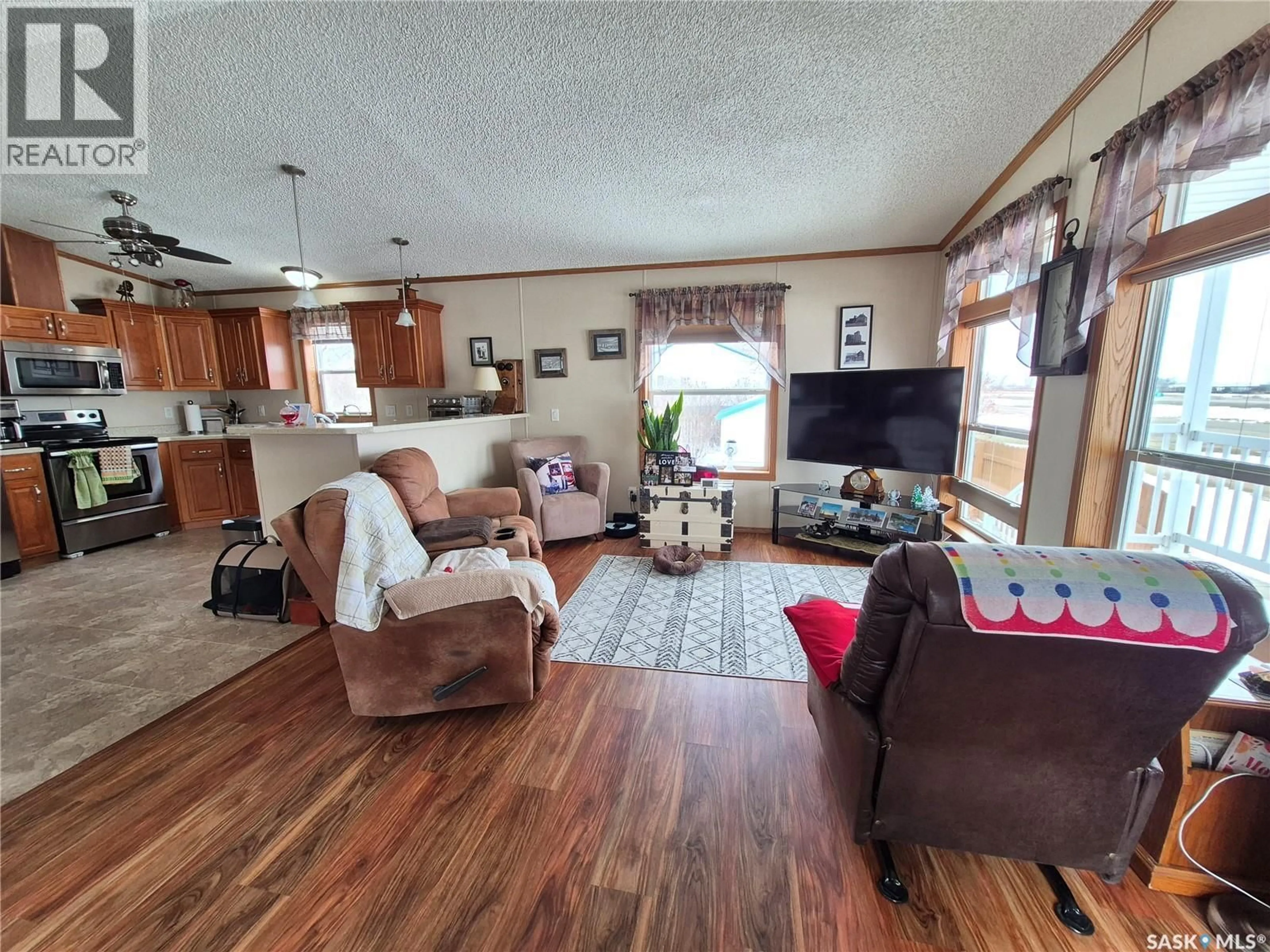 Living room with furniture, wood/laminate floor for 4425 ACCESS ROAD, Halbrite Saskatchewan S0C1H0