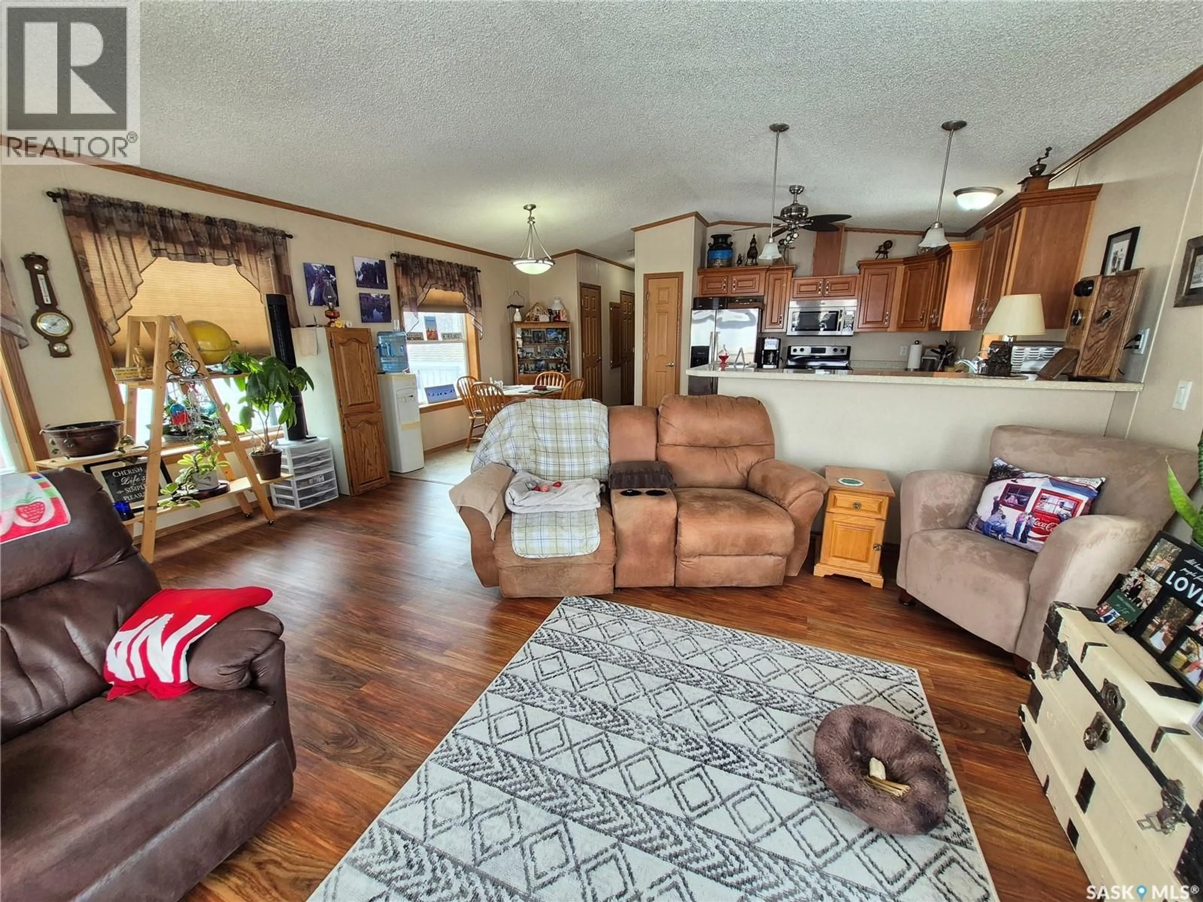 Living room with furniture, wood/laminate floor for 4425 ACCESS ROAD, Halbrite Saskatchewan S0C1H0