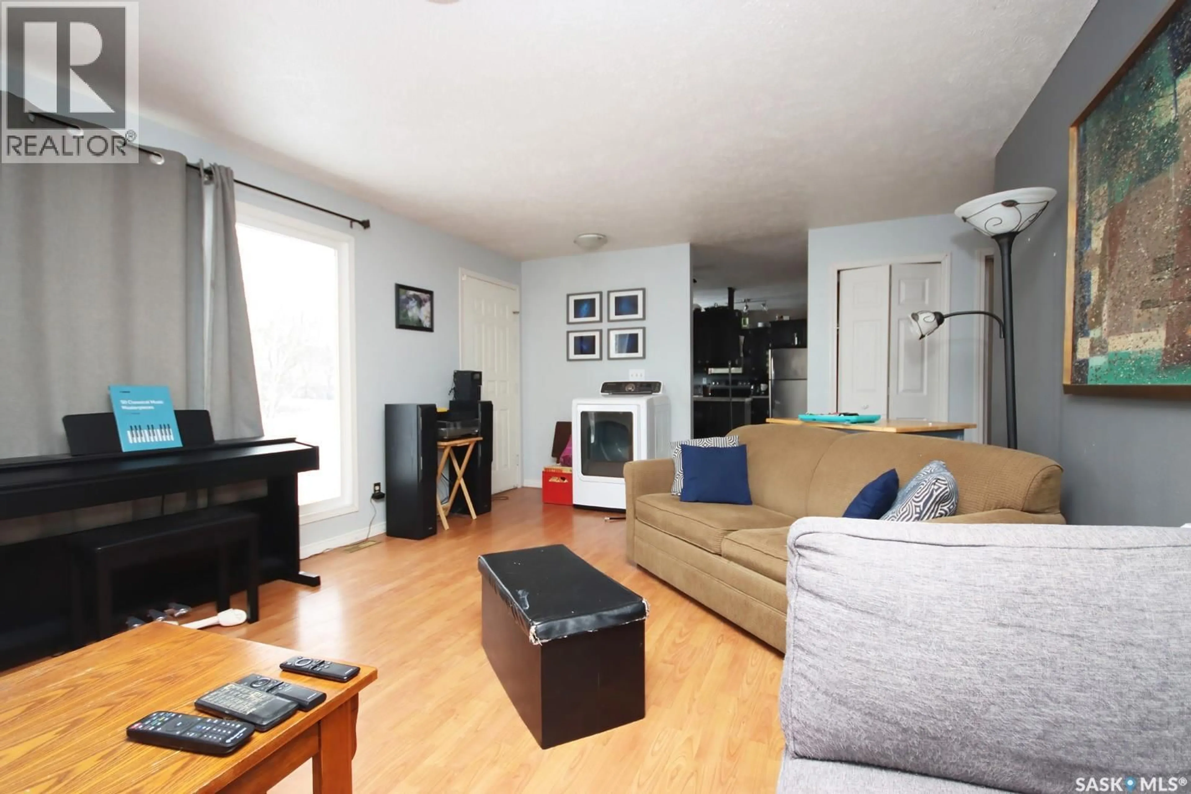 Living room with furniture, wood/laminate floor for 560 TALLMAN STREET, Macoun Saskatchewan S0C1P0