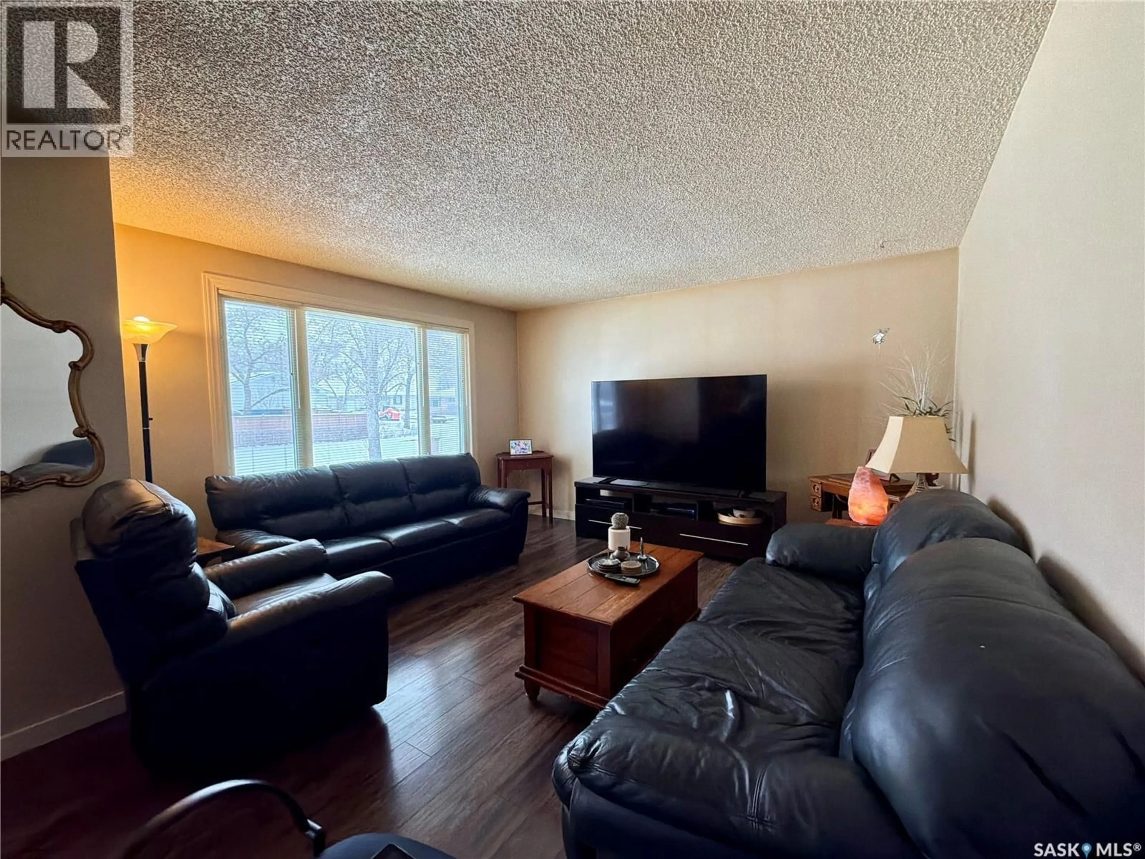 Living room with furniture, wood/laminate floor for 518 UPLAND DRIVE, Regina Saskatchewan S4R6E3