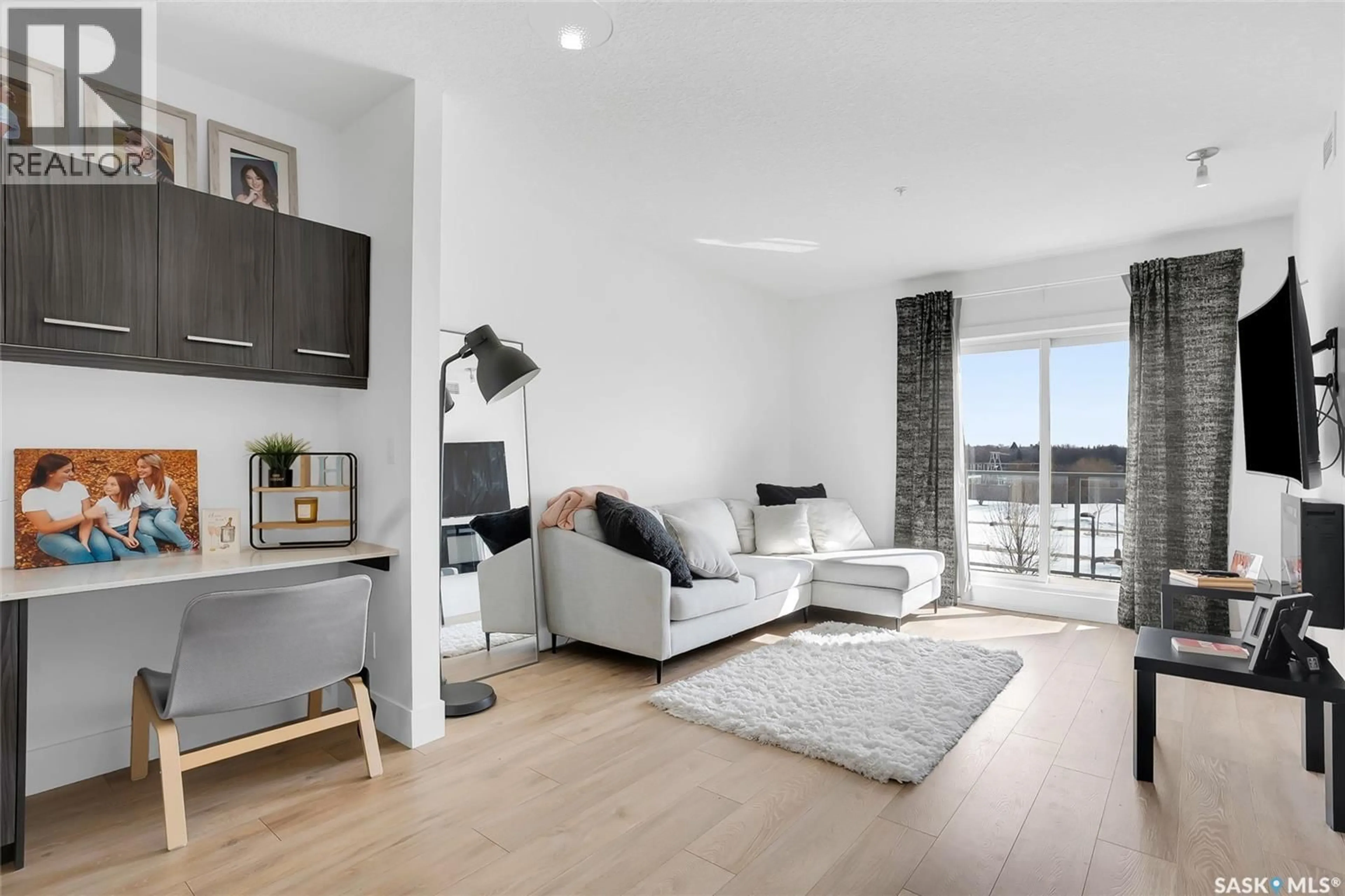 Living room with furniture, wood/laminate floor for 206 - 404 C AVENUE S, Saskatoon Saskatchewan S7M5M9