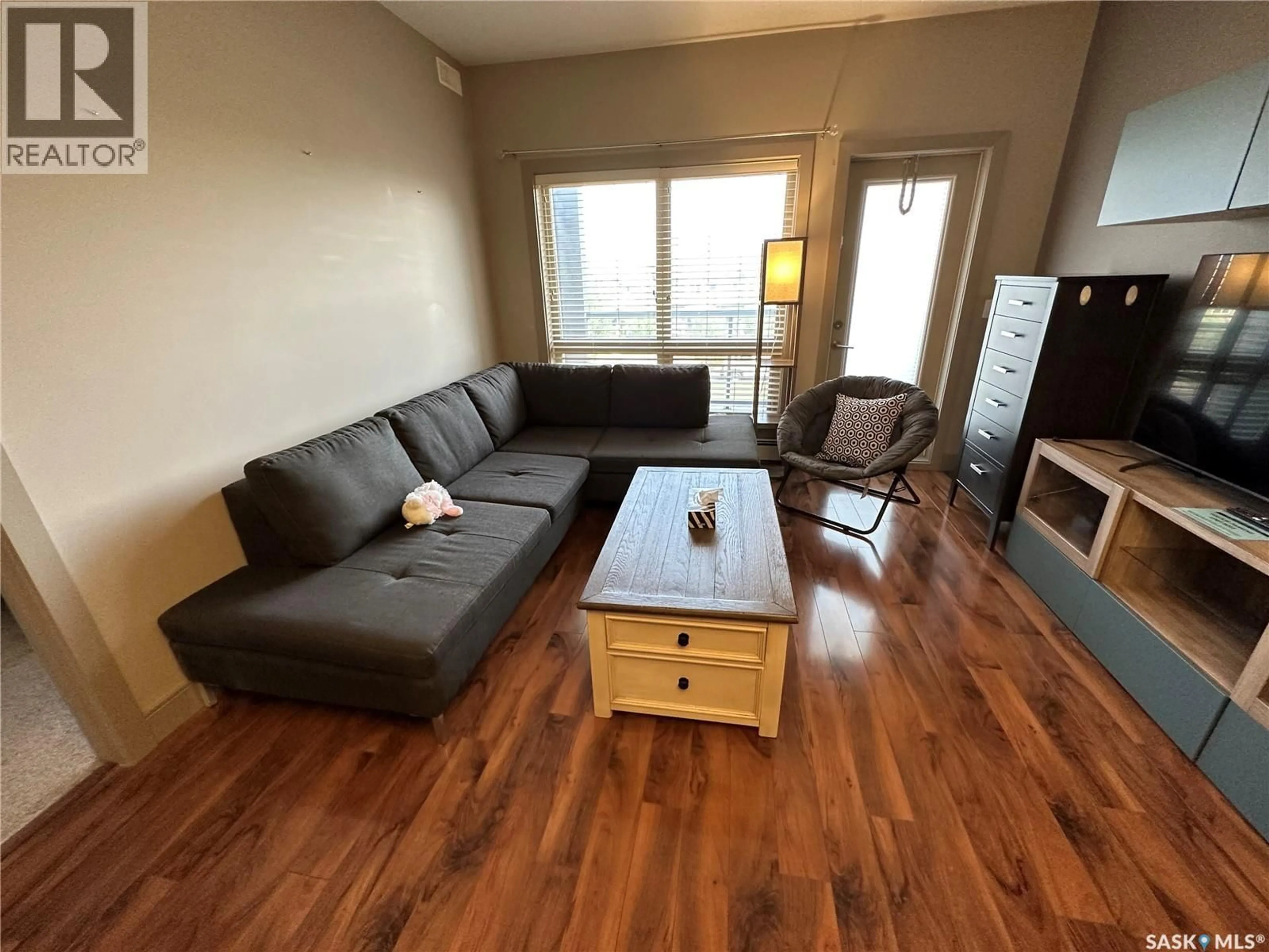 Living room with furniture, wood/laminate floor for 115 - 211 WILLOWGROVE CRESCENT, Saskatoon Saskatchewan S7H0M3