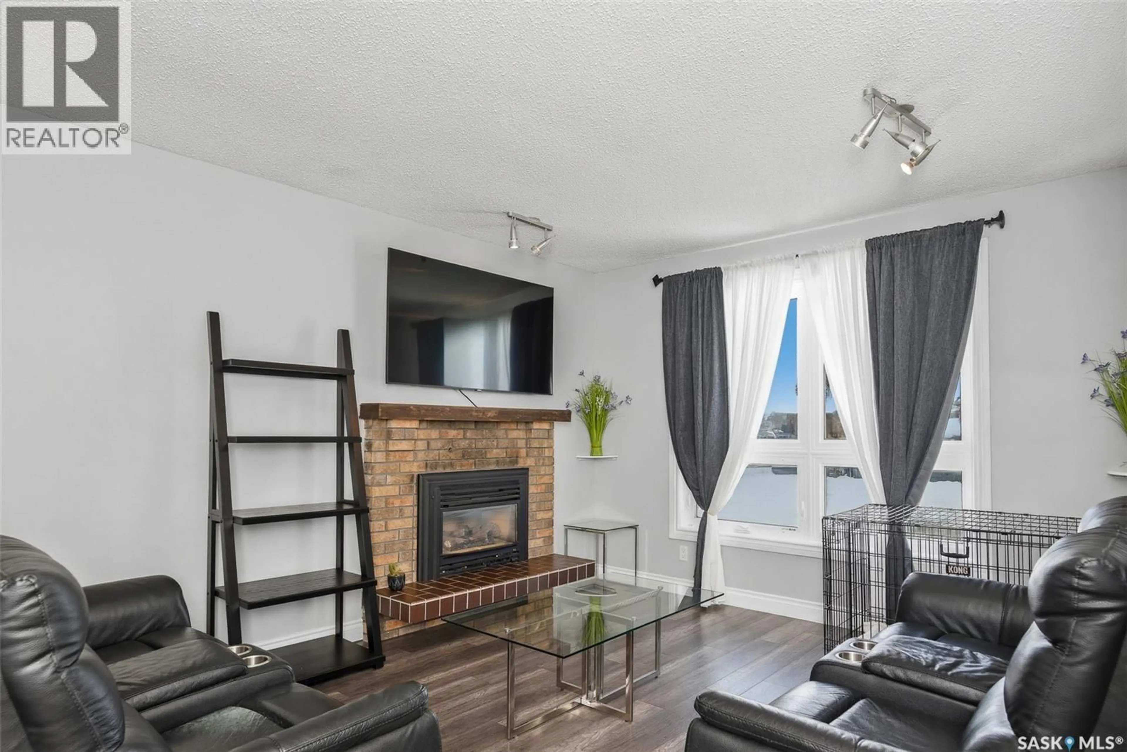 Living room with furniture, wood/laminate floor for 1107 GRAHAM ROAD, Regina Saskatchewan S4N5Z7