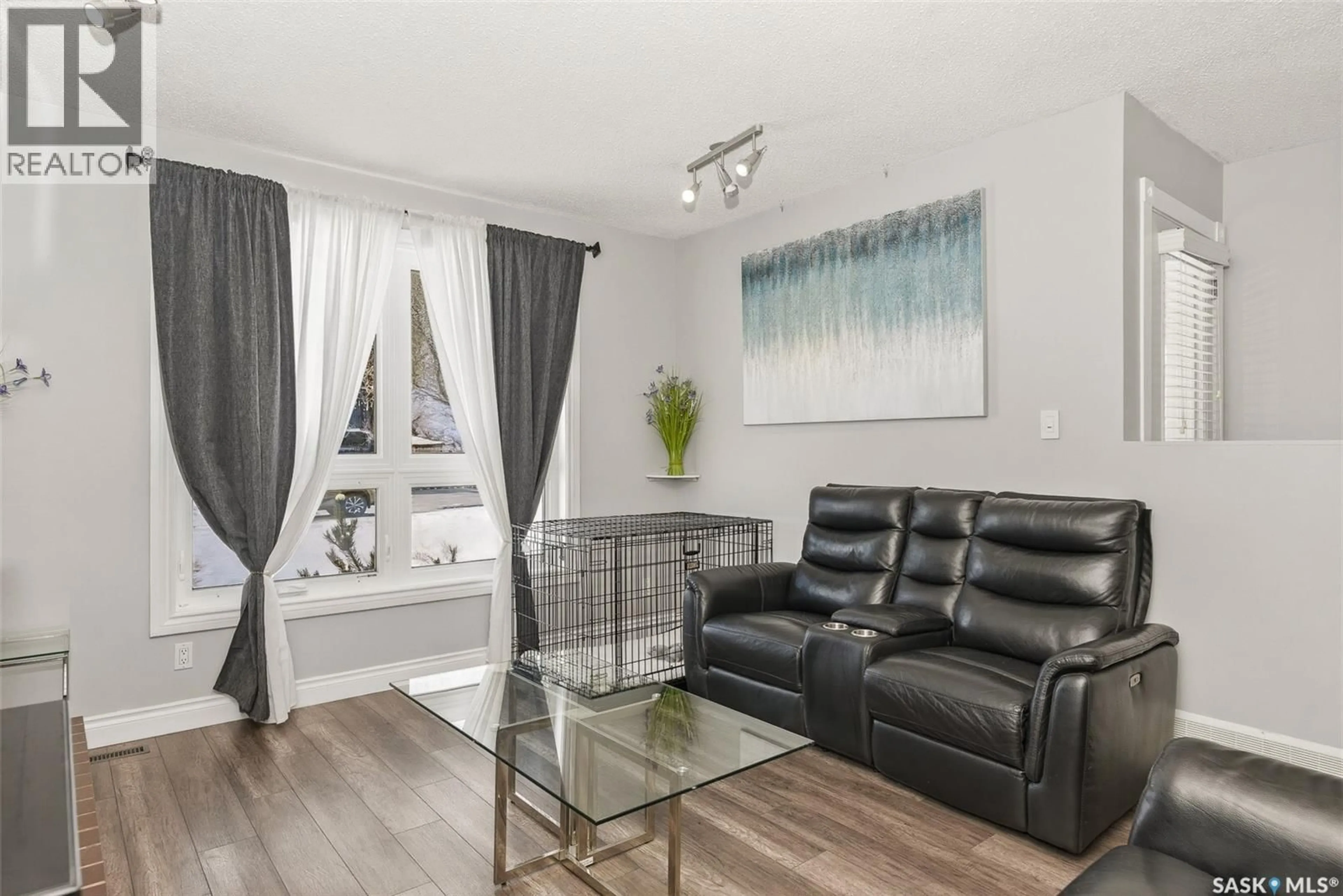 Living room with furniture, wood/laminate floor for 1107 GRAHAM ROAD, Regina Saskatchewan S4N5Z7