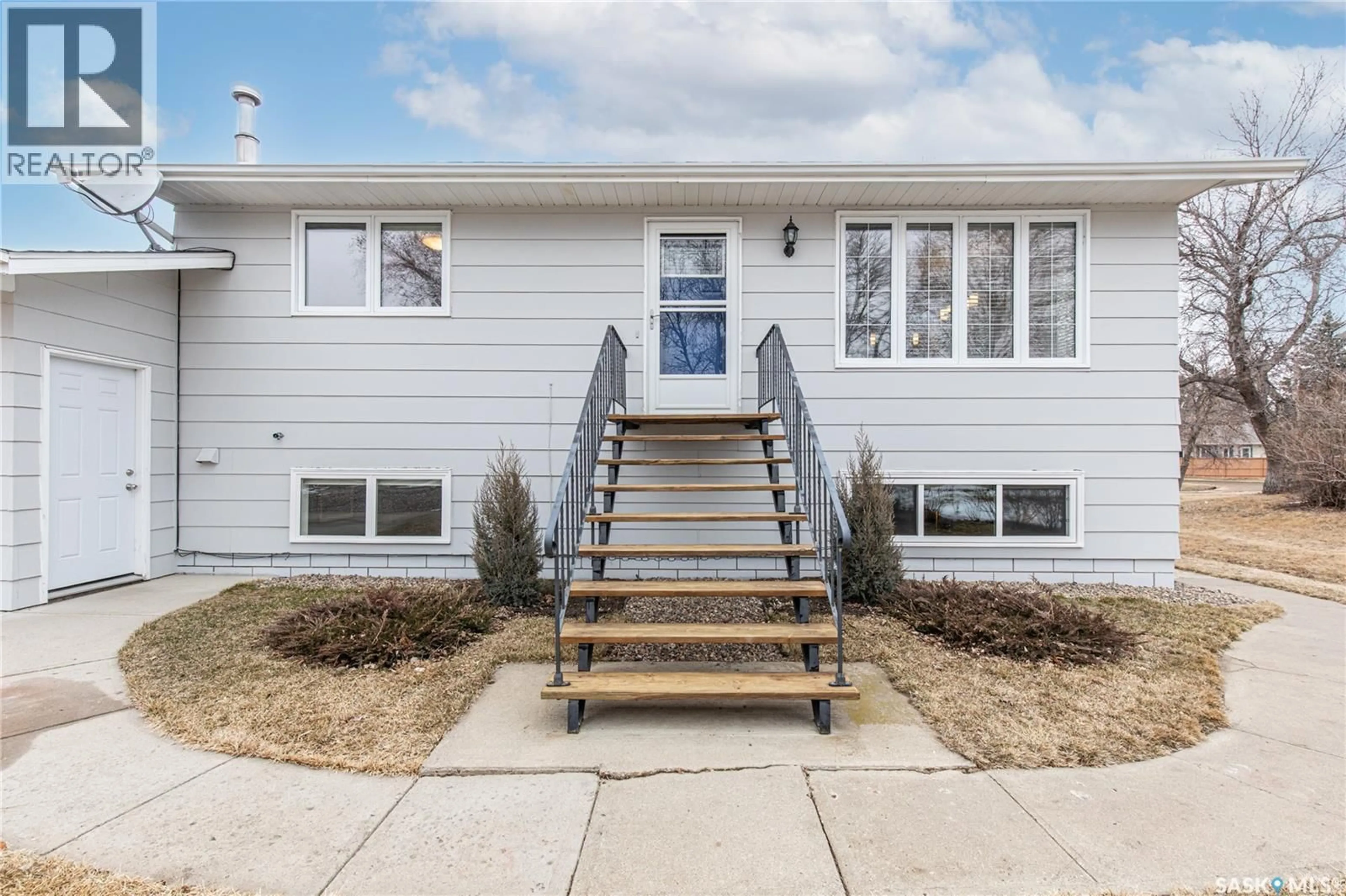 Home with vinyl exterior material, street for 219 CEDAR CRESCENT, Caronport Saskatchewan S0H0S0