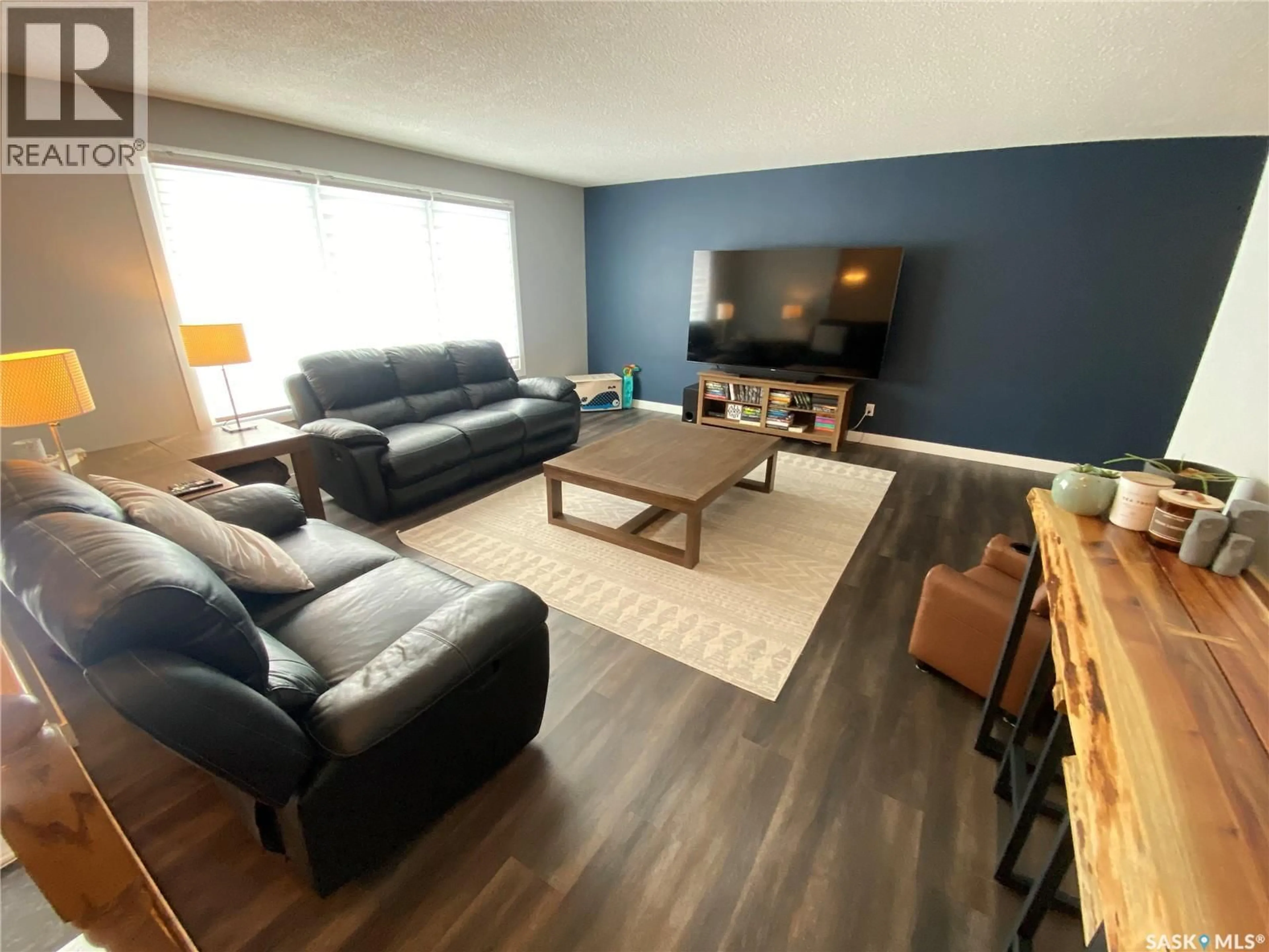 Living room with furniture, wood/laminate floor for 117 STEWART CRESCENT, Yorkton Saskatchewan S3N3J4