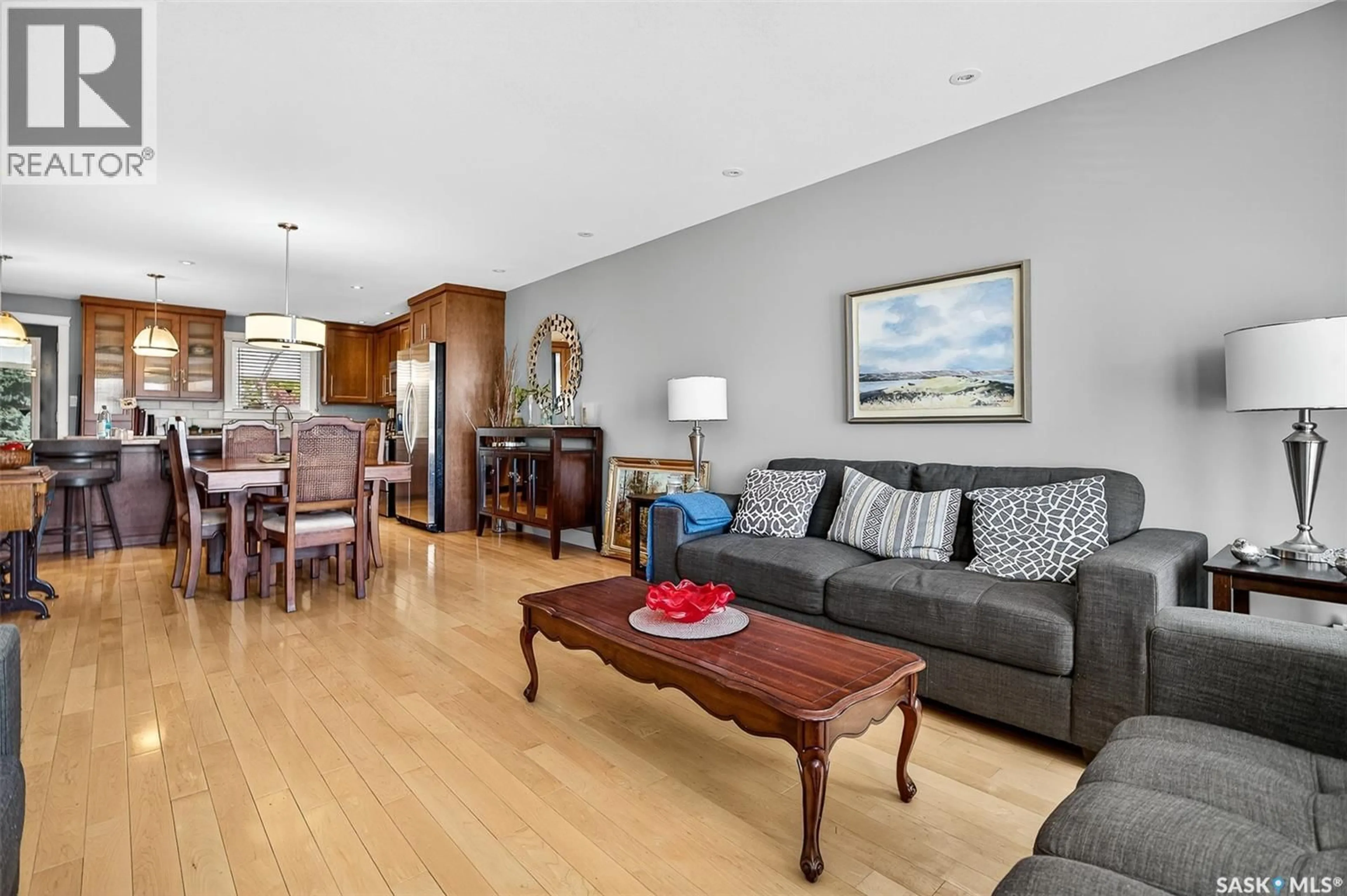 Living room with furniture, wood/laminate floor for 133 WOOD LILY DRIVE, Moose Jaw Saskatchewan S6J1E9