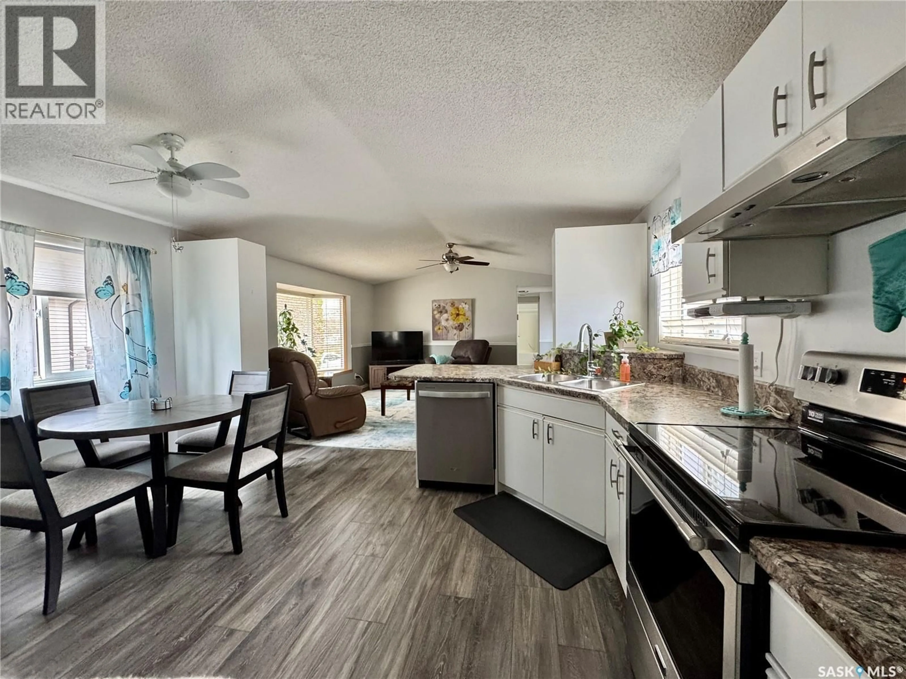 Open concept kitchen, wood/laminate floor for E - 317 RIEDEL AVENUE, Langenburg Saskatchewan S0A2A0