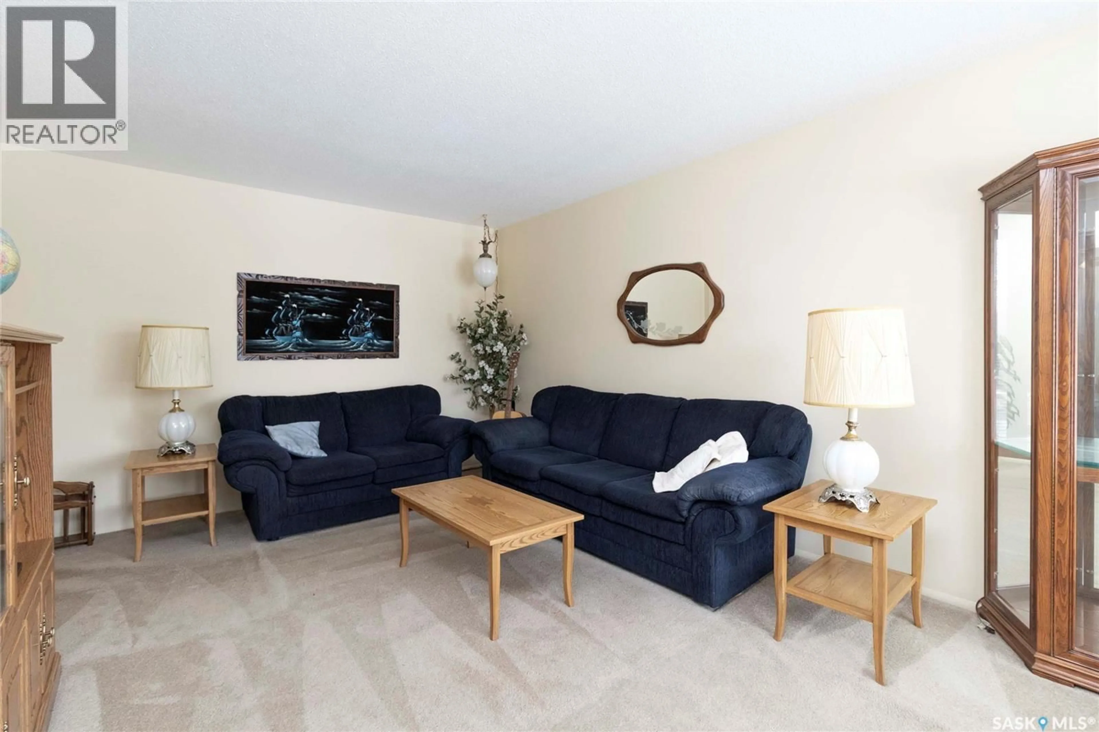 Living room with furniture, wood/laminate floor for 24 ANDERSON CRESCENT, Saskatoon Saskatchewan S7H3Z8