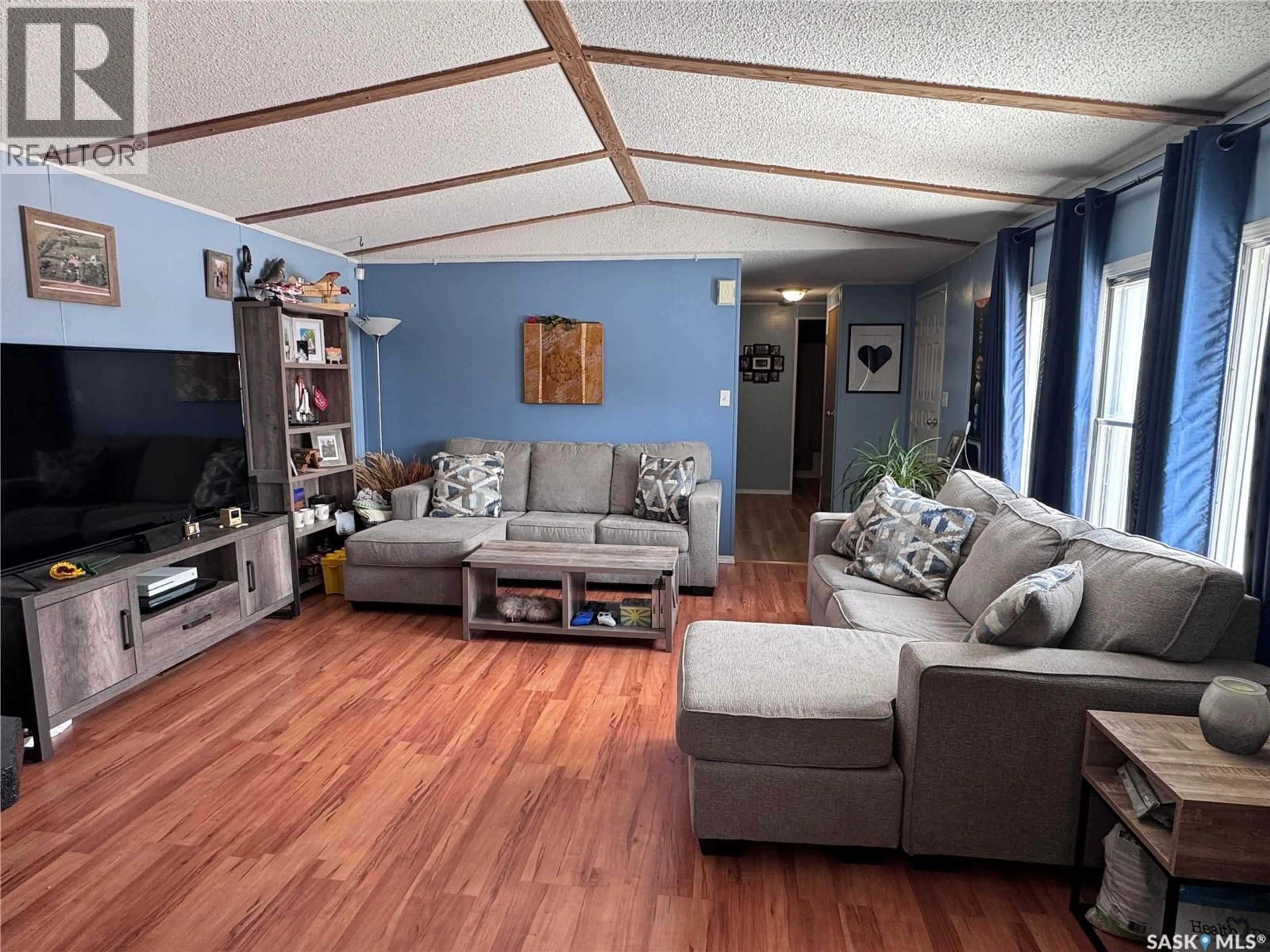 Living room with furniture, wood/laminate floor for 1111 RIESE DRIVE, La Ronge Saskatchewan S0J1L0