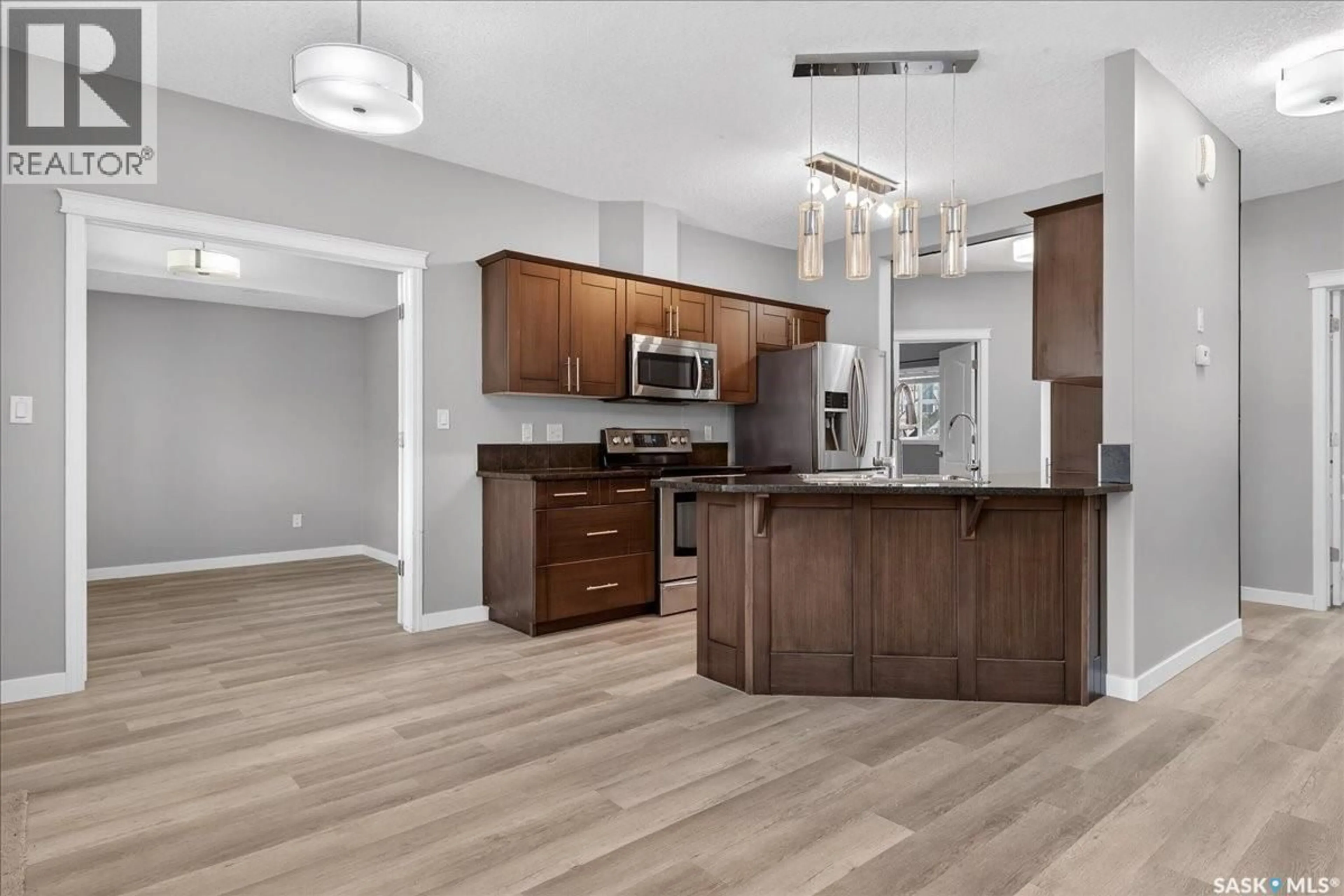 Open concept kitchen, wood/laminate floor for 3806 - 713 DEWDNEY AVENUE E, Regina Saskatchewan S4Z0A6