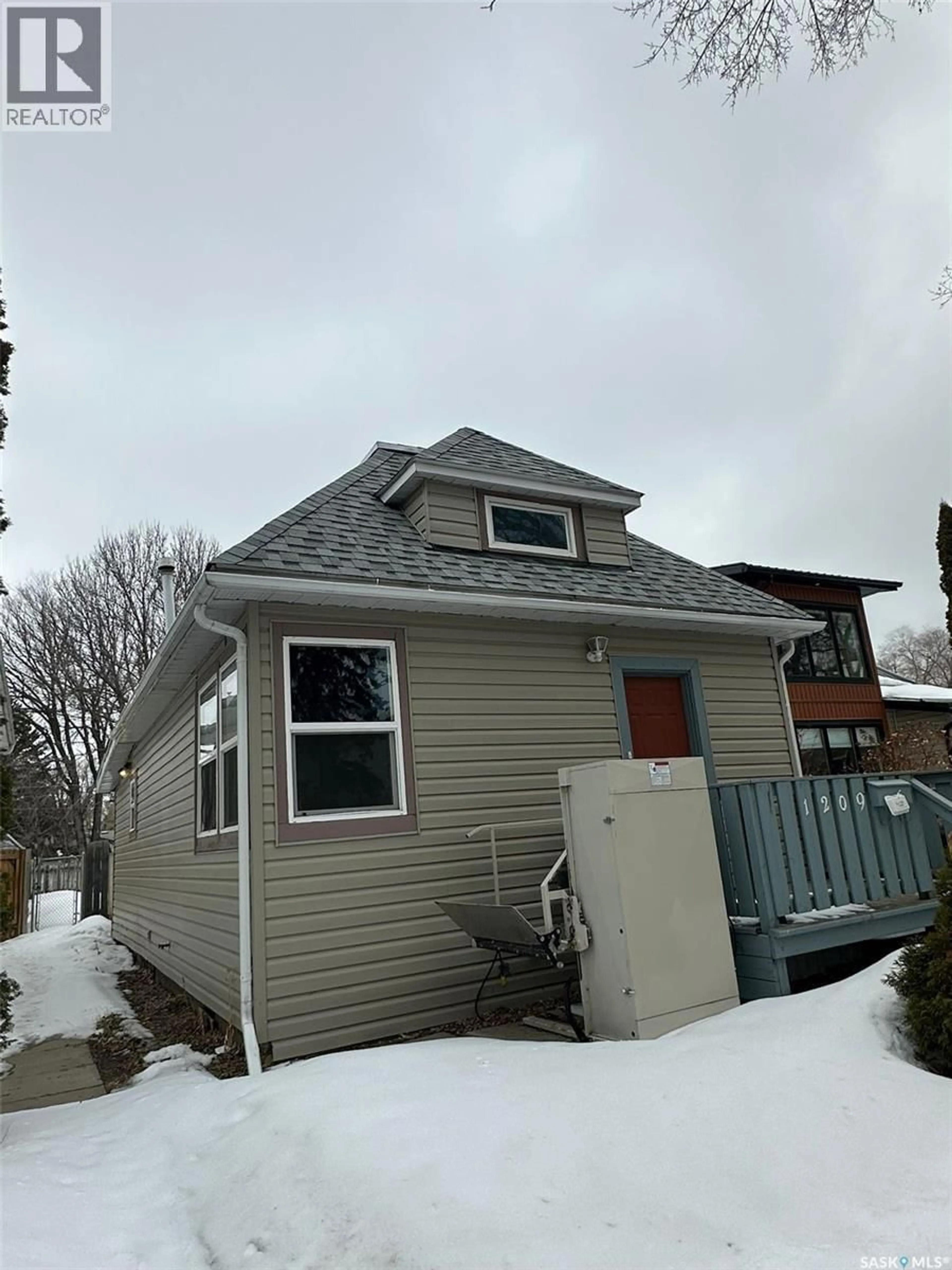 Home with vinyl exterior material, street for 1209 K AVENUE, Saskatoon Saskatchewan S7M2G6