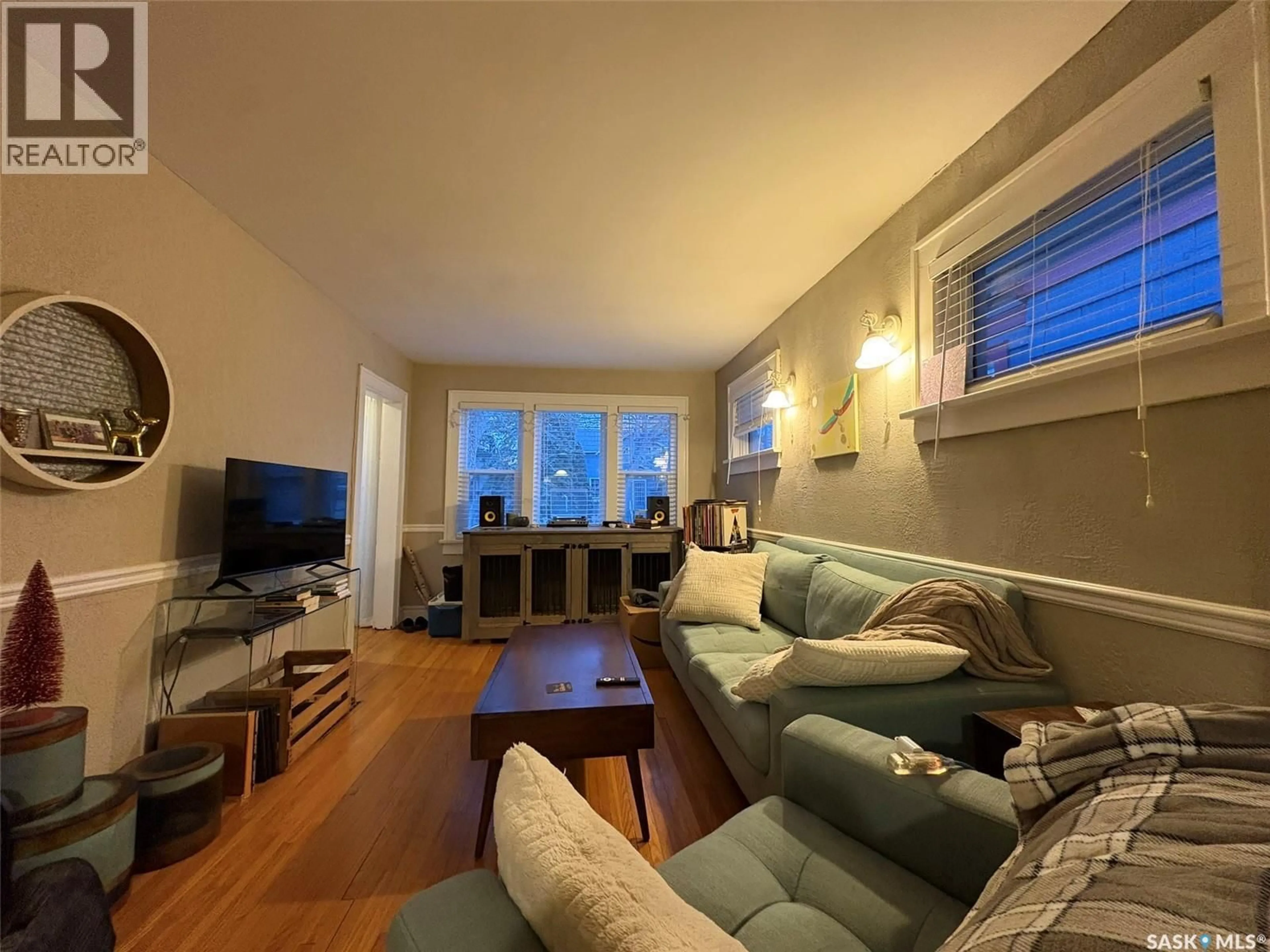 Living room with furniture, wood/laminate floor for 2470 WALLACE STREET, Regina Saskatchewan S4N4B3