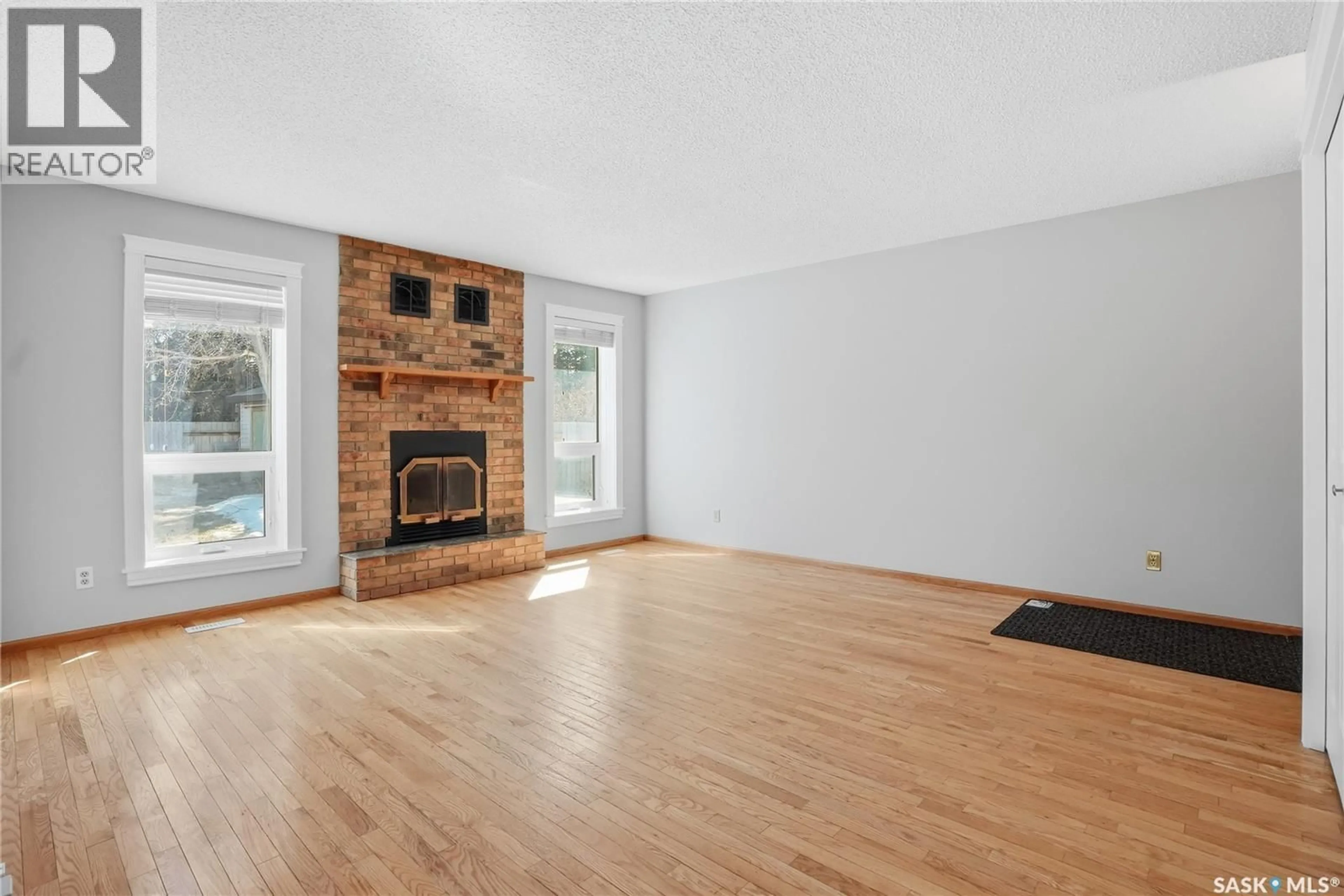 Living room with furniture, wood/laminate floor for 223 MEILICKE ROAD, Saskatoon Saskatchewan S7K5V6