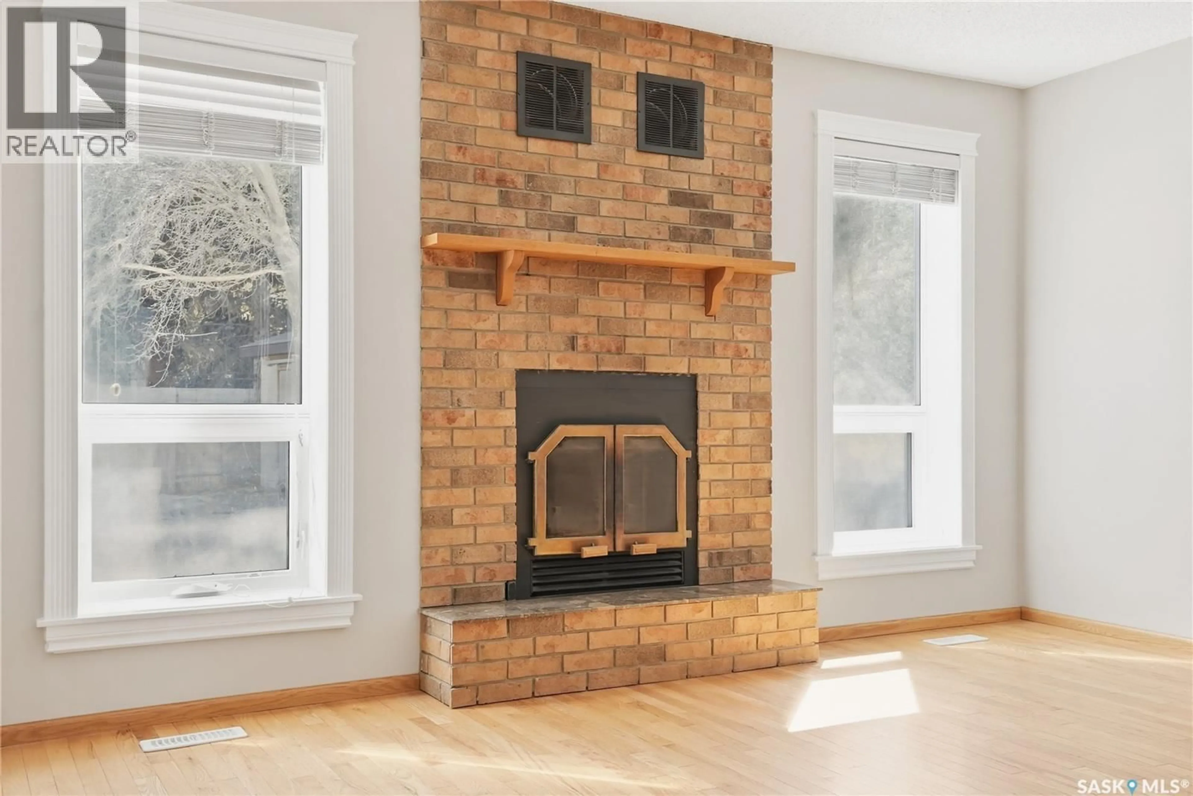 Living room with furniture, wood/laminate floor for 223 MEILICKE ROAD, Saskatoon Saskatchewan S7K5V6