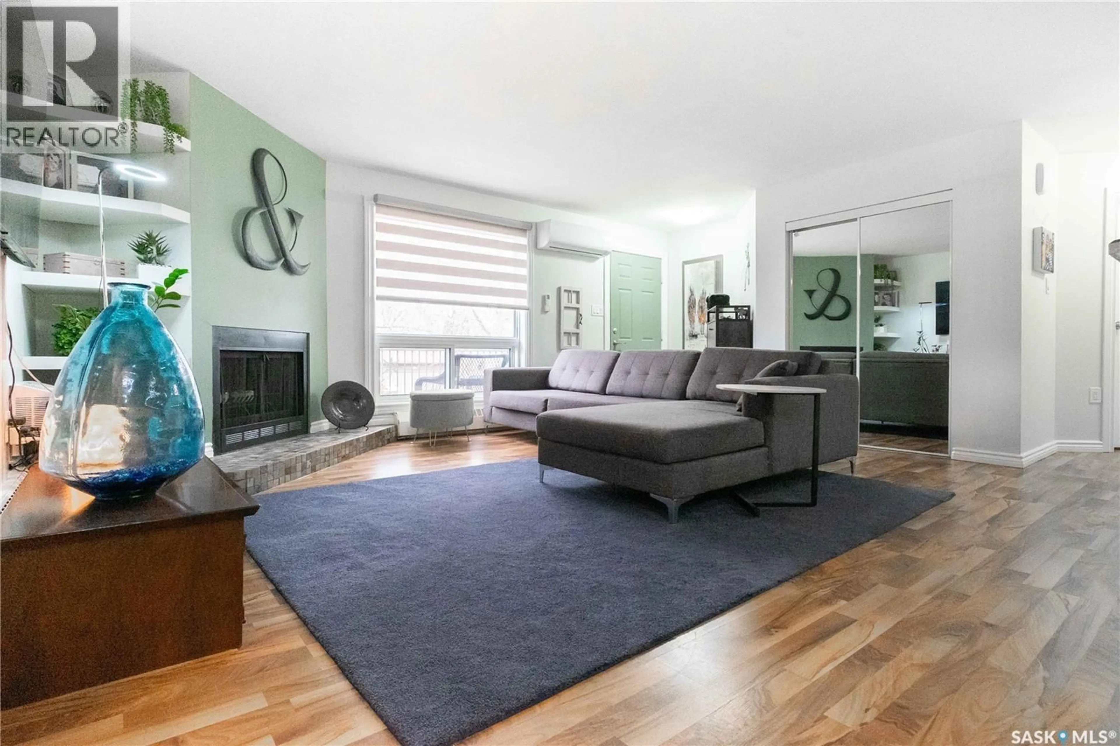 Living room with furniture, wood/laminate floor for 202 - 2911 HARDING STREET, Regina Saskatchewan S4V1B9