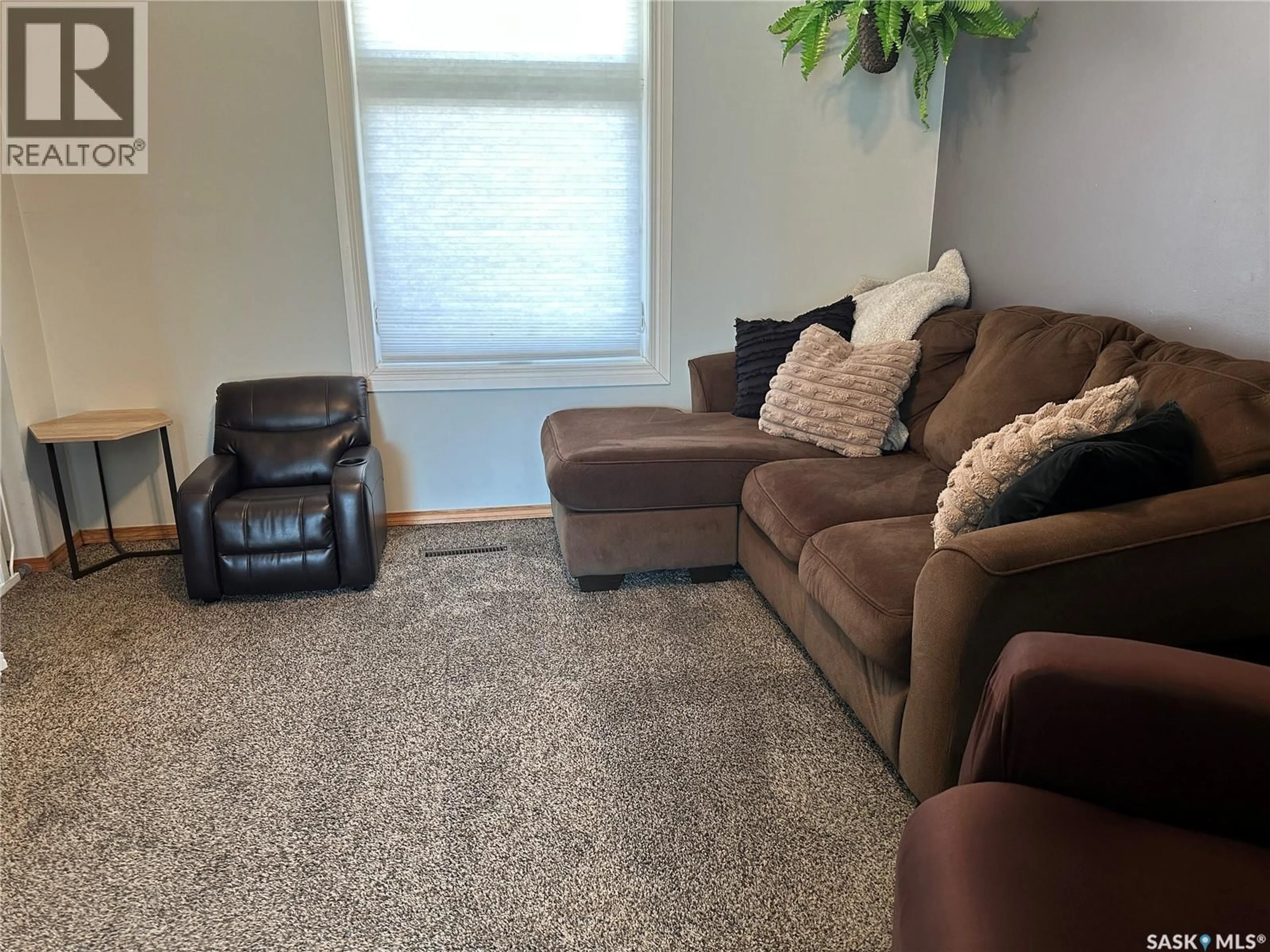 Living room with furniture, carpet floor for 24 3RD AVENUE, Weyburn Saskatchewan S4H1X2
