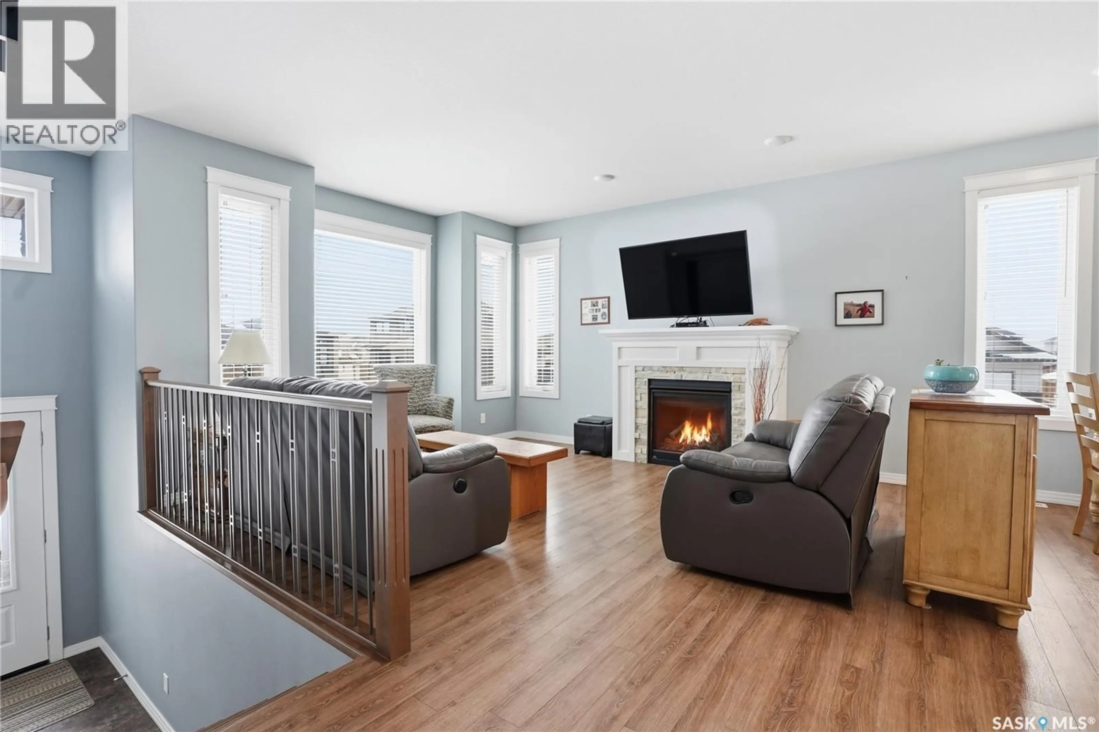 Living room with furniture, wood/laminate floor for 922 SALMON WAY, Martensville Saskatchewan S0K2T1