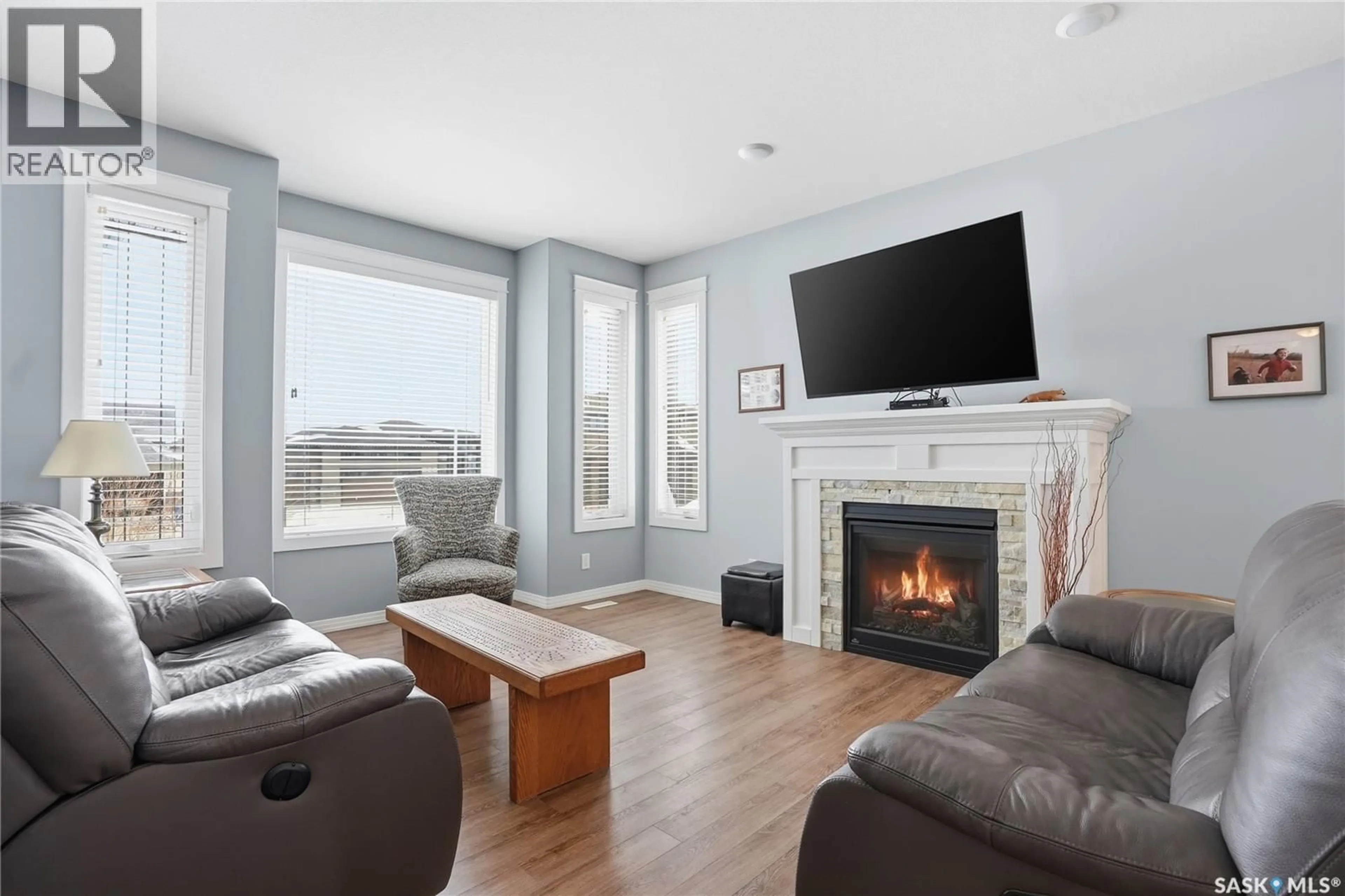 Living room with furniture, wood/laminate floor for 922 SALMON WAY, Martensville Saskatchewan S0K2T1