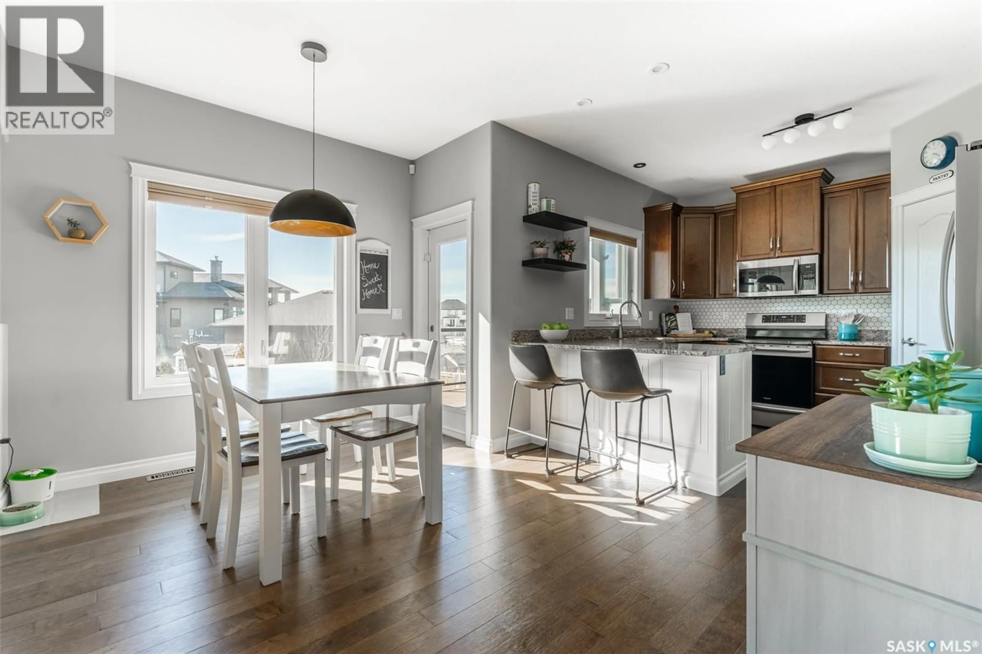 Open concept kitchen, wood/laminate floor for 562 EVERGREEN BOULEVARD, Saskatoon Saskatchewan S7W0M8