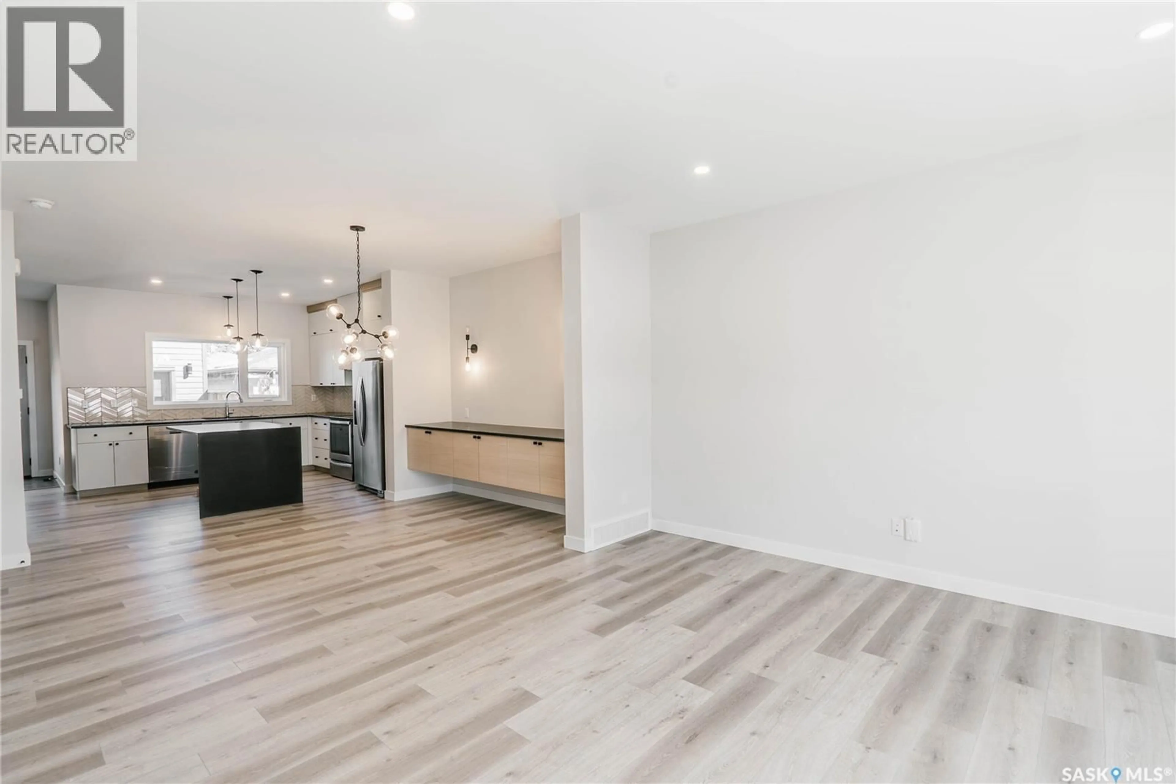 Open concept kitchen, wood/laminate floor for 803 2ND STREET, Saskatoon Saskatchewan S7H1P8
