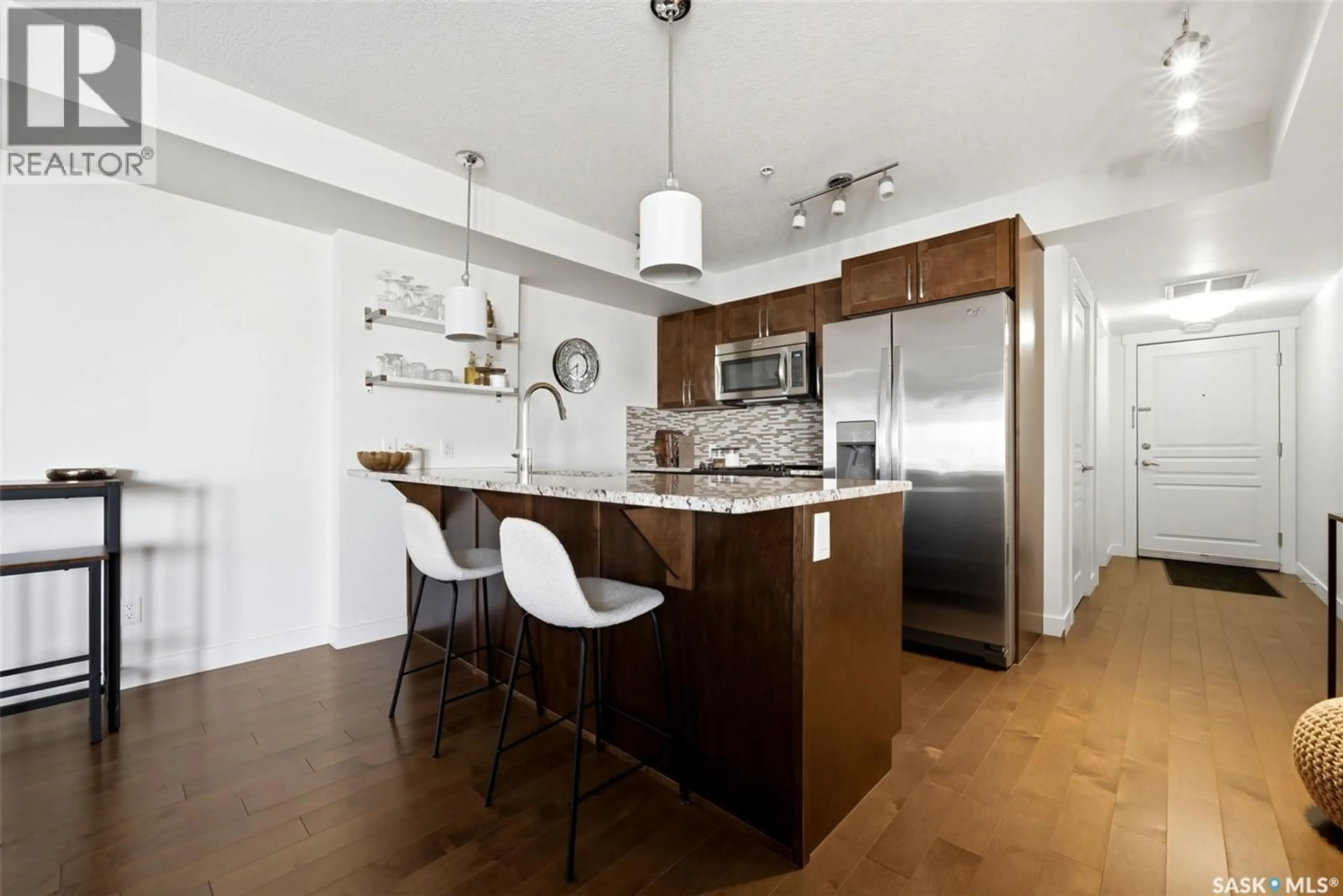 Open concept kitchen, wood/laminate floor for 5301 - 312 UNIVERSAL CRESCENT, Regina Saskatchewan S4W0L2