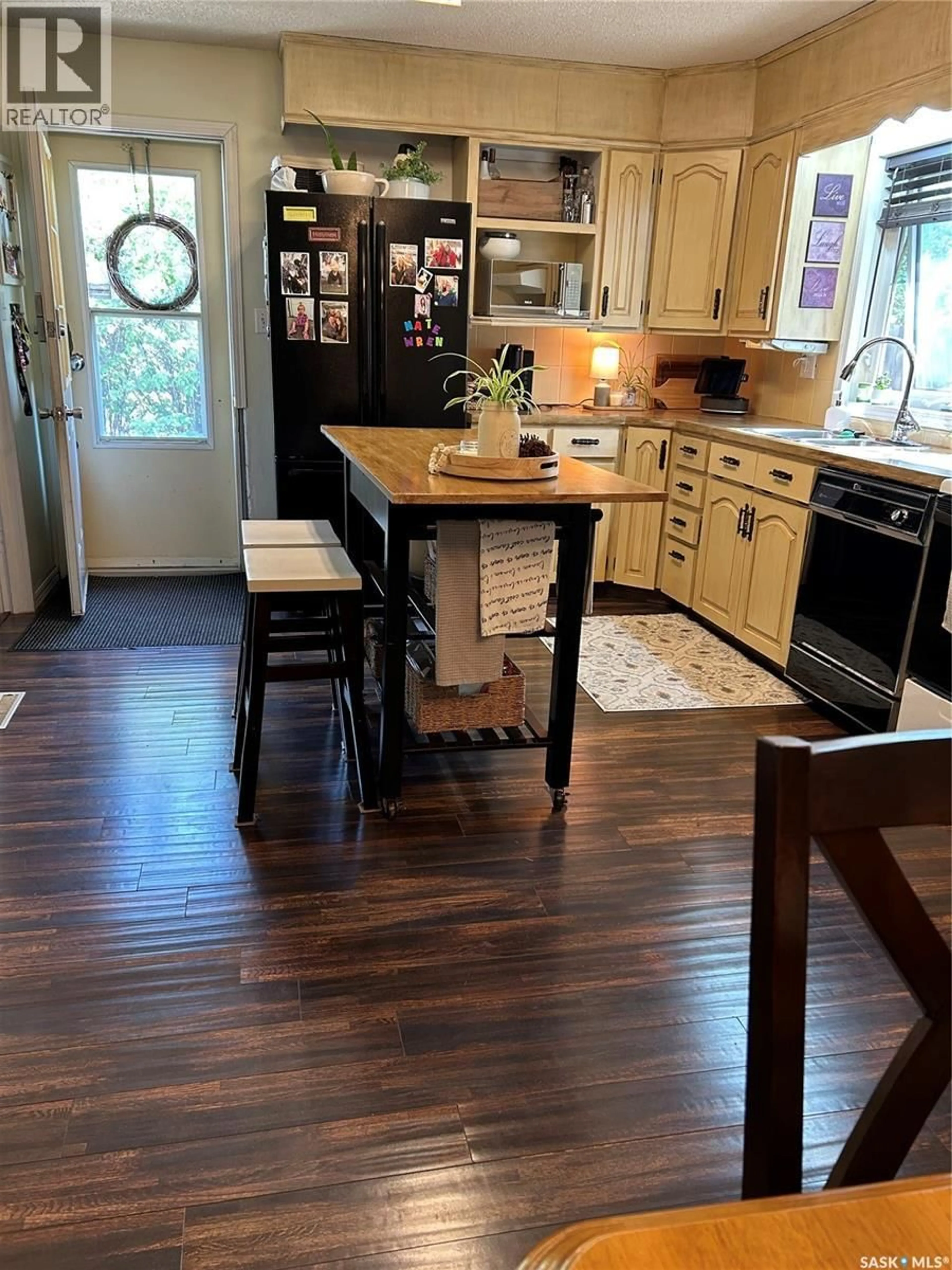 Open concept kitchen, wood/laminate floor for 1533 THORN CRESCENT, Estevan Saskatchewan S4A1N7