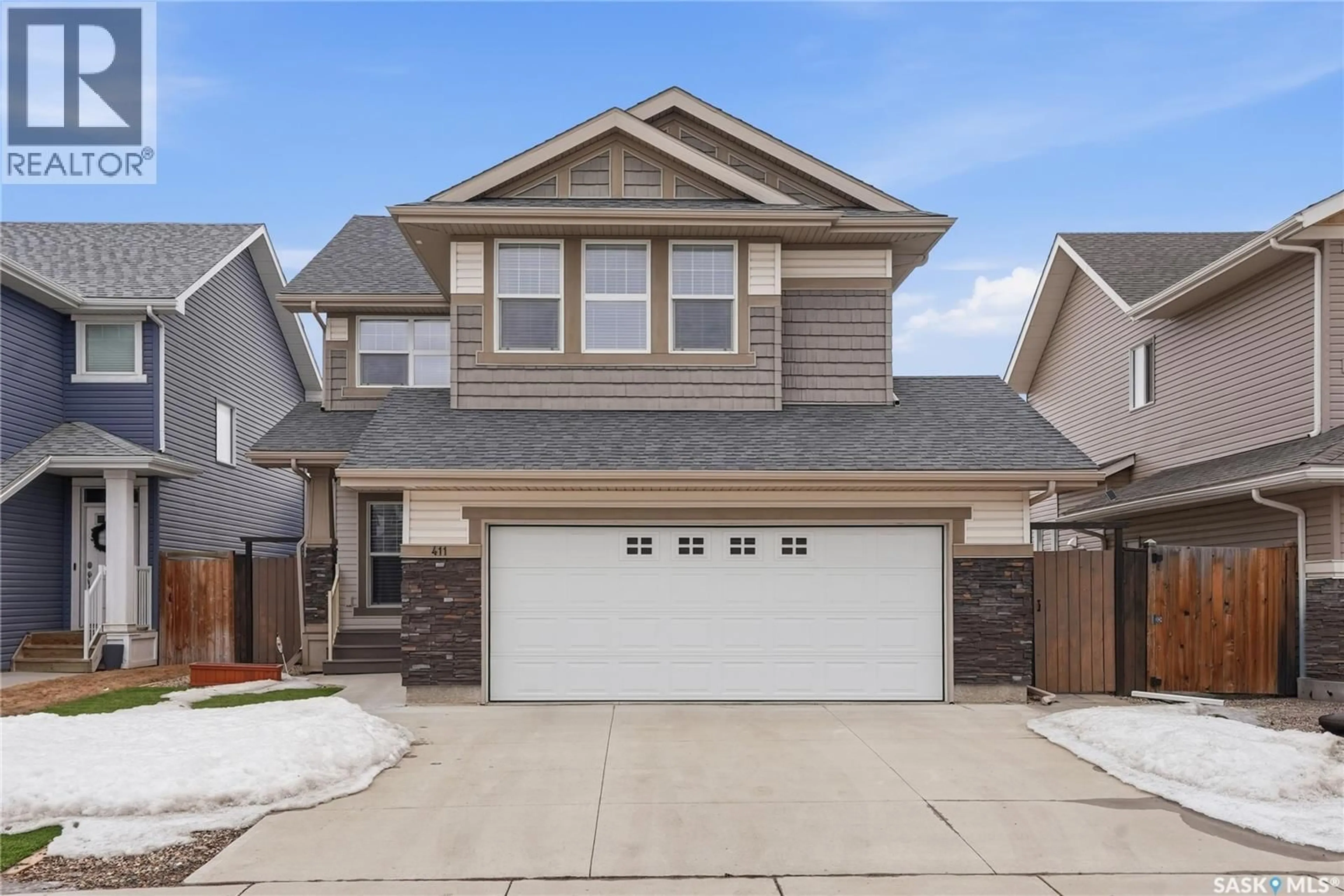 Home with vinyl exterior material, street for 411 FLYNN LANE, Saskatoon Saskatchewan S7V0L1