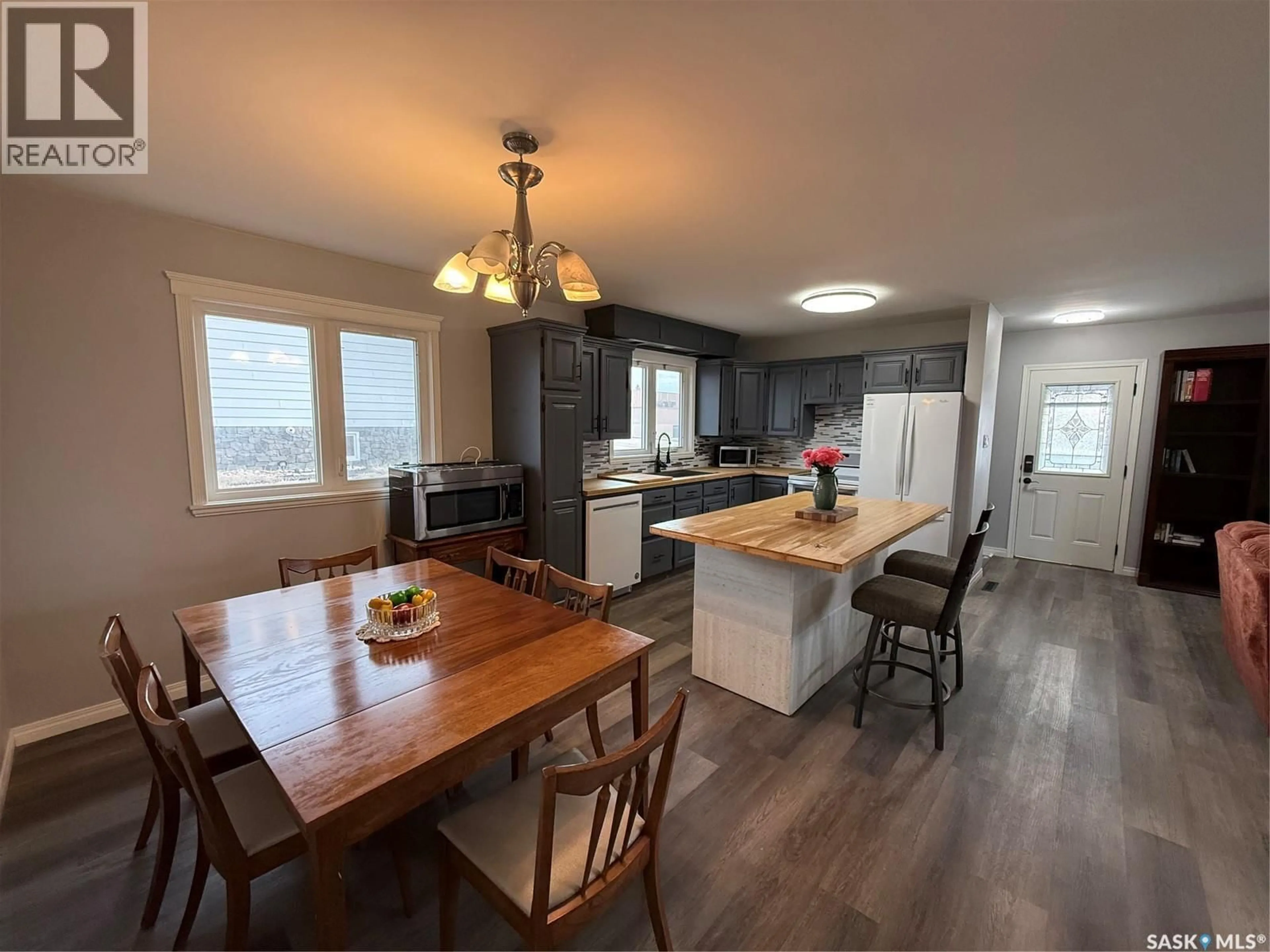 Open concept kitchen, wood/laminate floor for 801 LORNE STREET, Swift Current Saskatchewan S9H0J8
