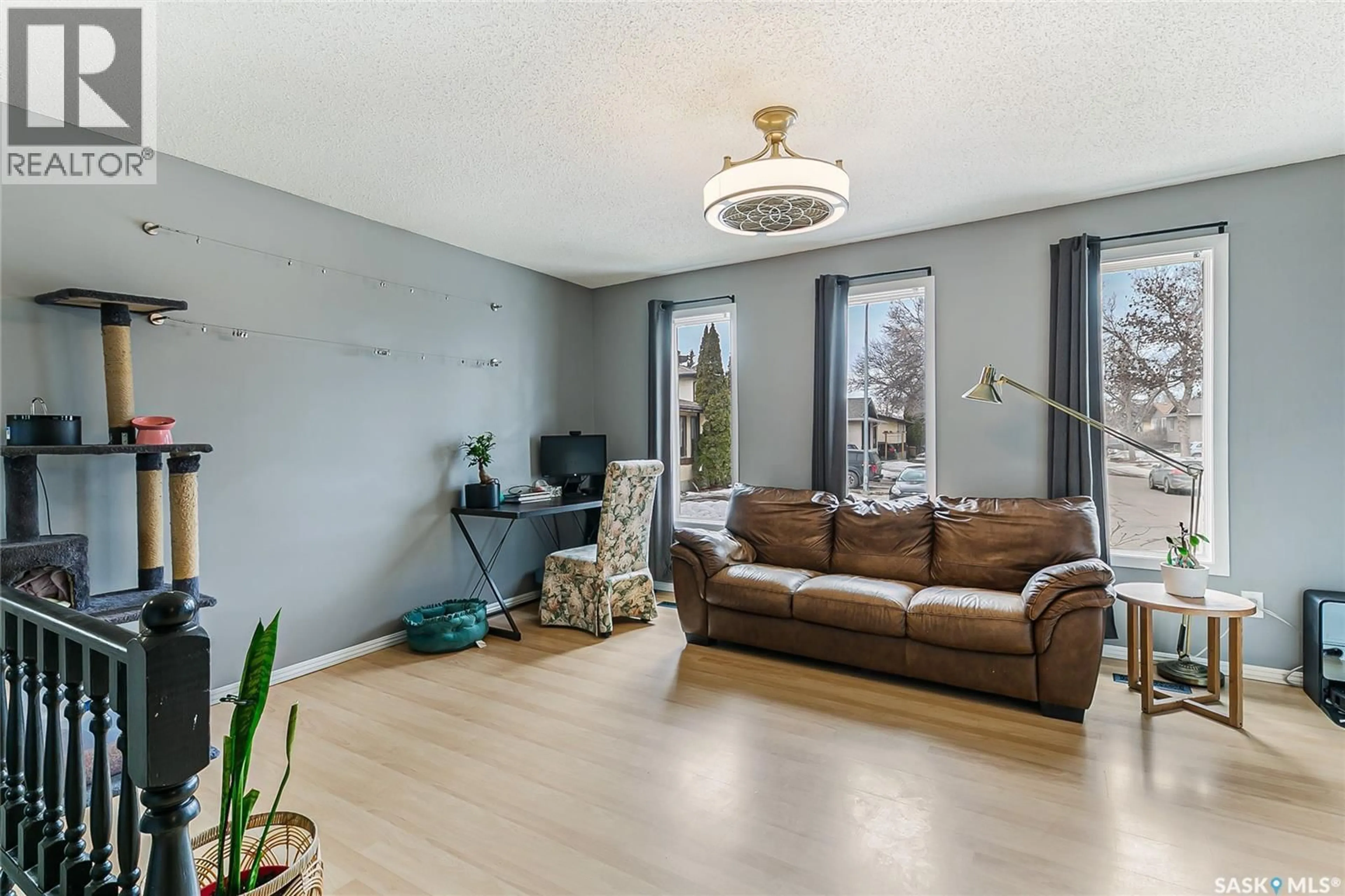 Living room with furniture, wood/laminate floor for 7354 BLAKENEY DRIVE, Regina Saskatchewan S4X2M5