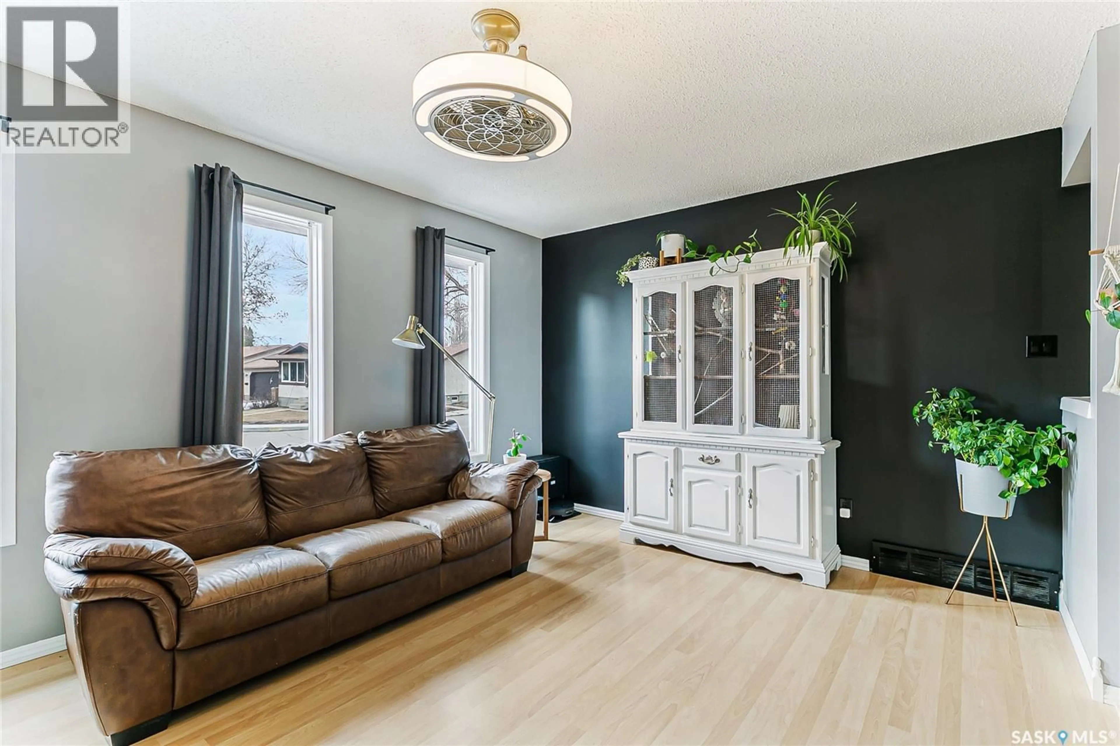 Living room with furniture, wood/laminate floor for 7354 BLAKENEY DRIVE, Regina Saskatchewan S4X2M5