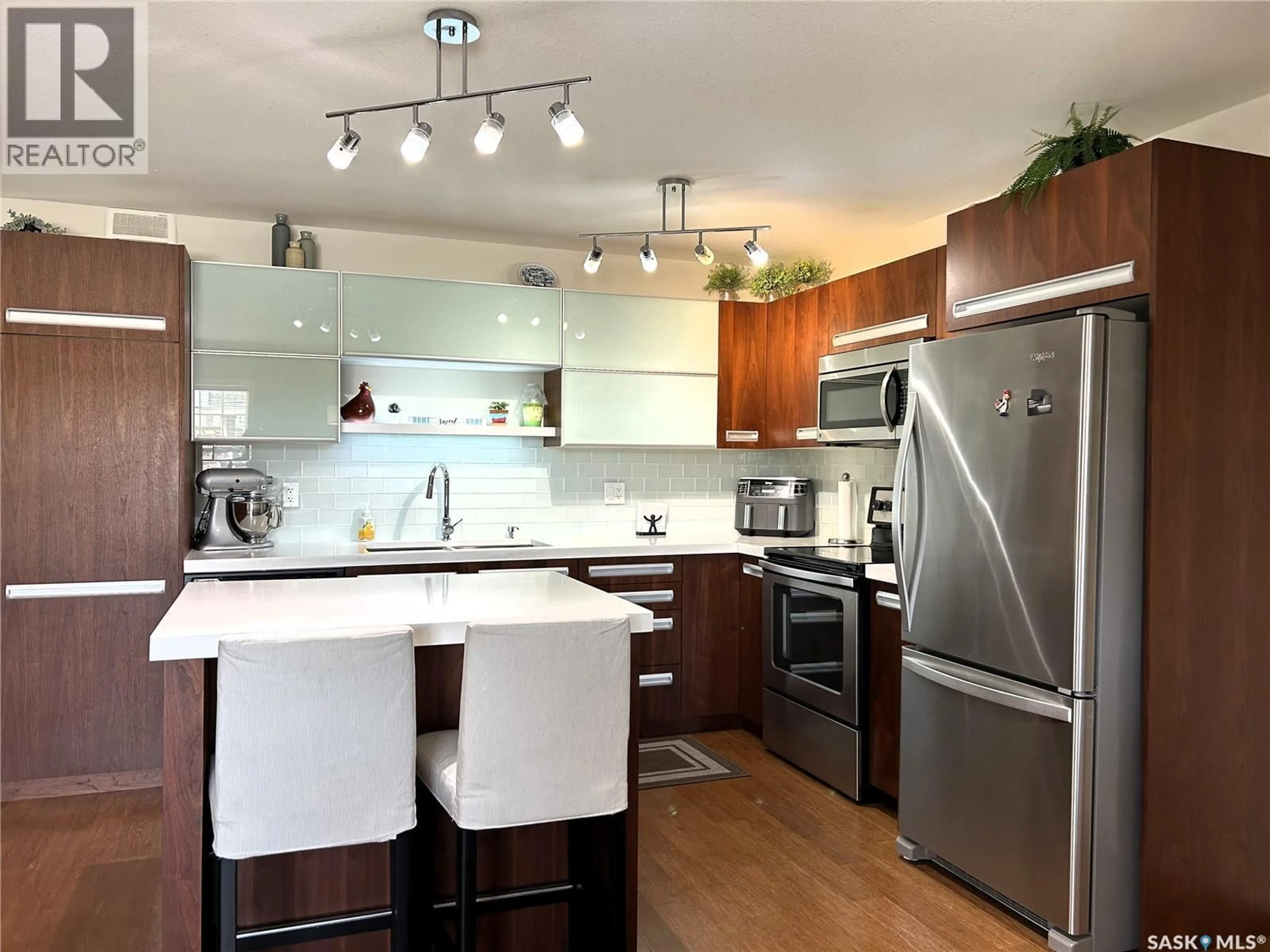 Open concept kitchen, wood/laminate floor for 1015 - 1603 PATRICK CRESCENT, Saskatoon Saskatchewan S7W0M6