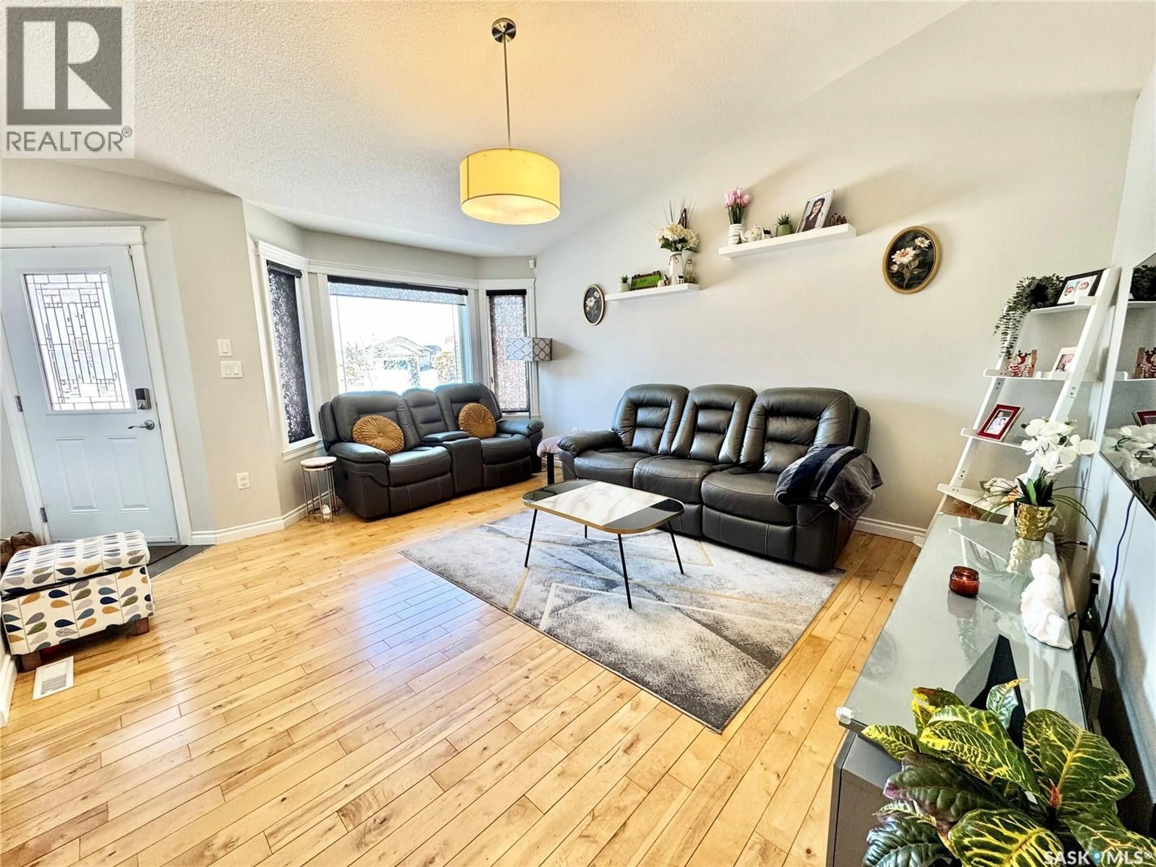 Living room with furniture, wood/laminate floor for 42 JOHN HICKS PLACE, Prince Albert Saskatchewan S6V8E5