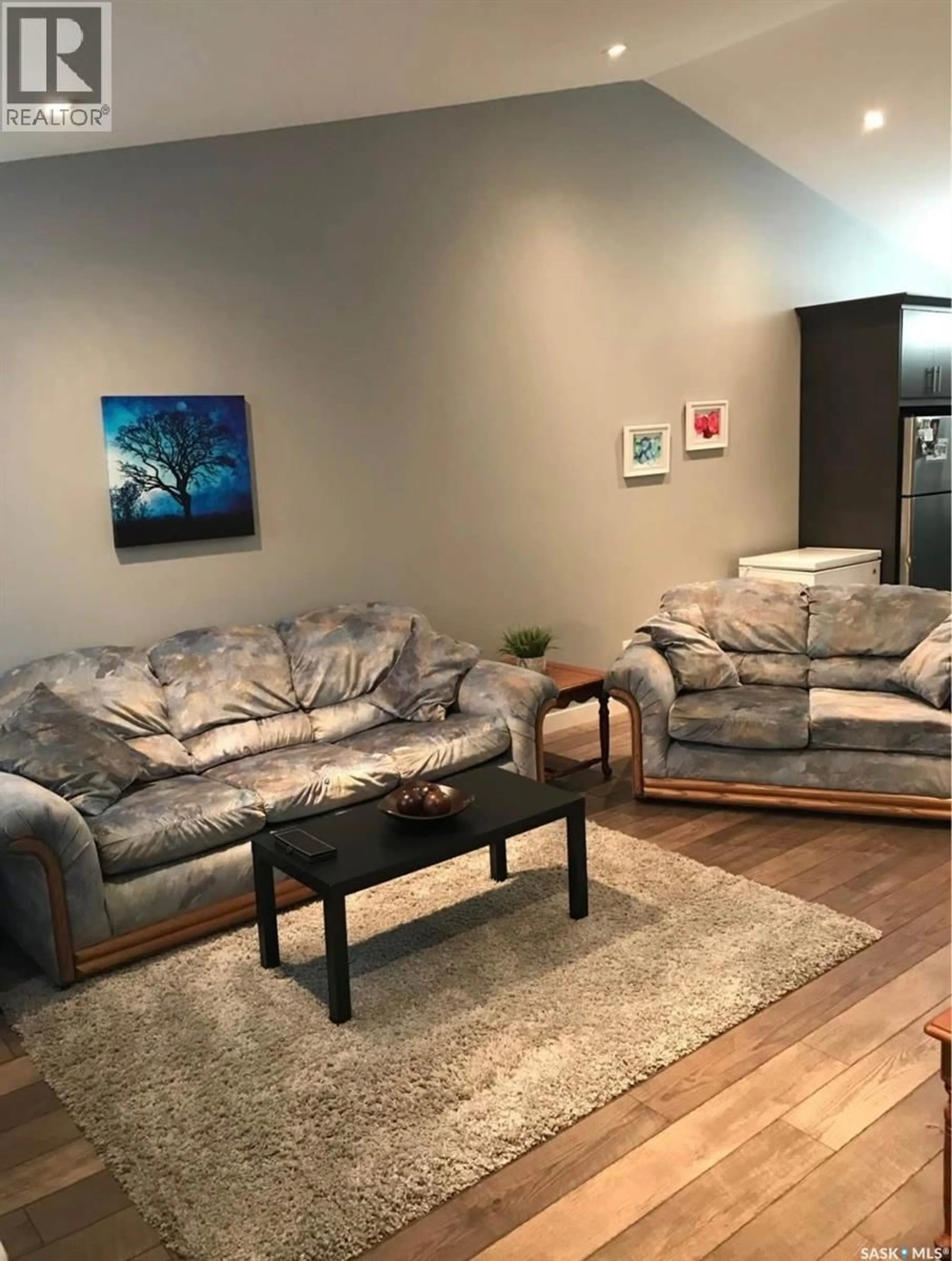 Living room with furniture, wood/laminate floor for 4183 GREEN APPLE DRIVE, Regina Saskatchewan S4V1P5