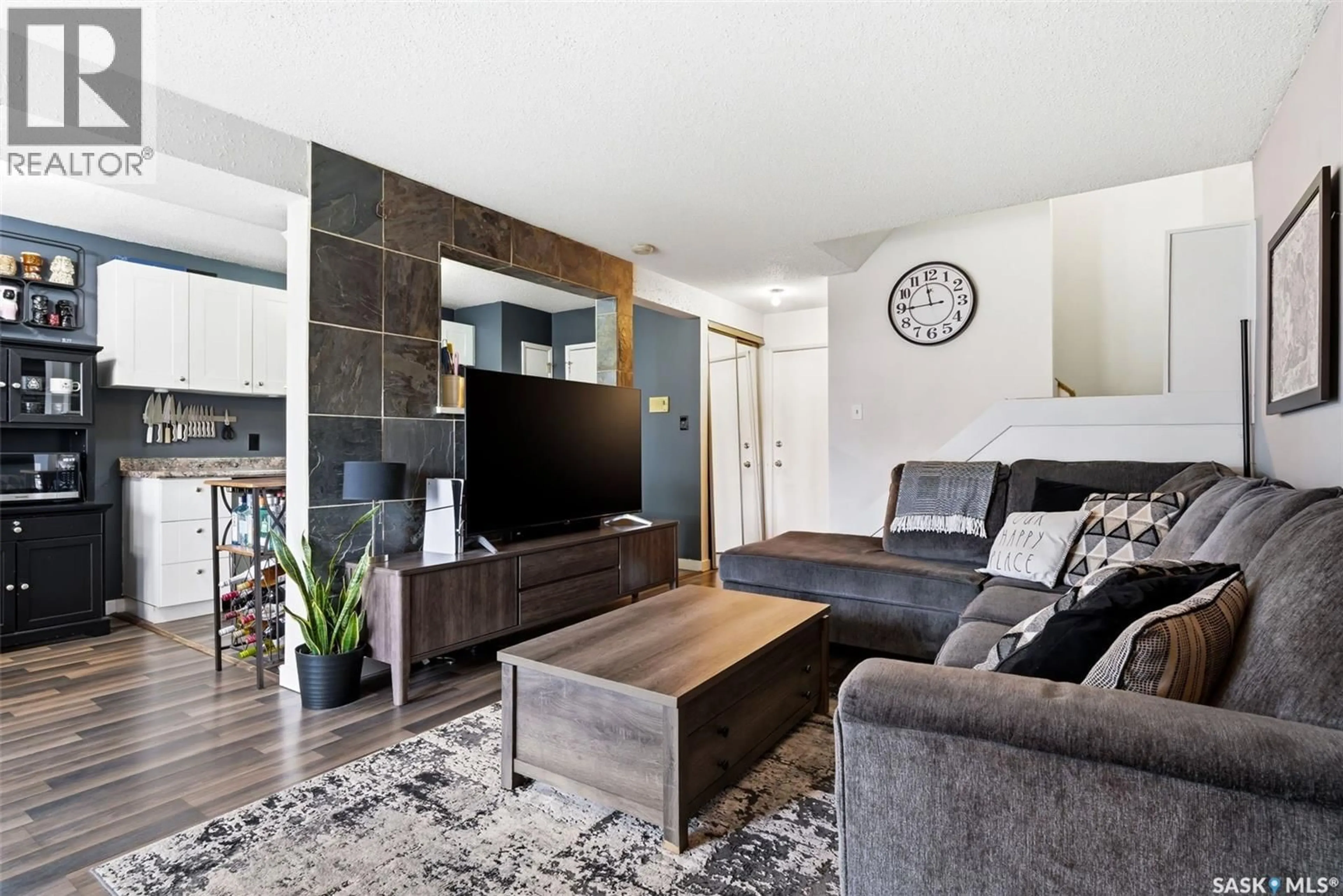 Living room with furniture, wood/laminate floor for 4212 CASTLE ROAD, Regina Saskatchewan S4S4W1