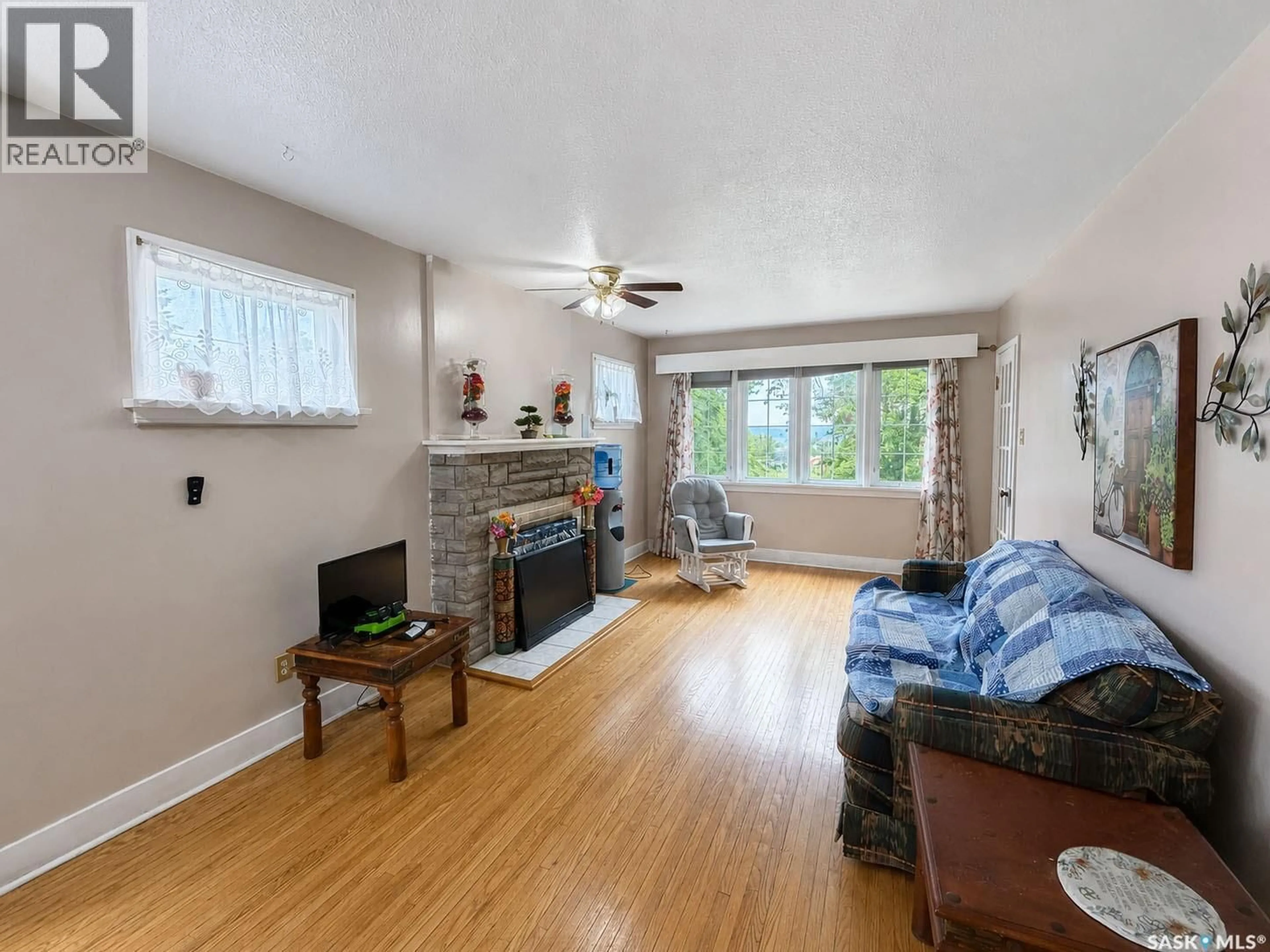 Living room with furniture, wood/laminate floor for 385 19TH STREET, Prince Albert Saskatchewan S6V4C8