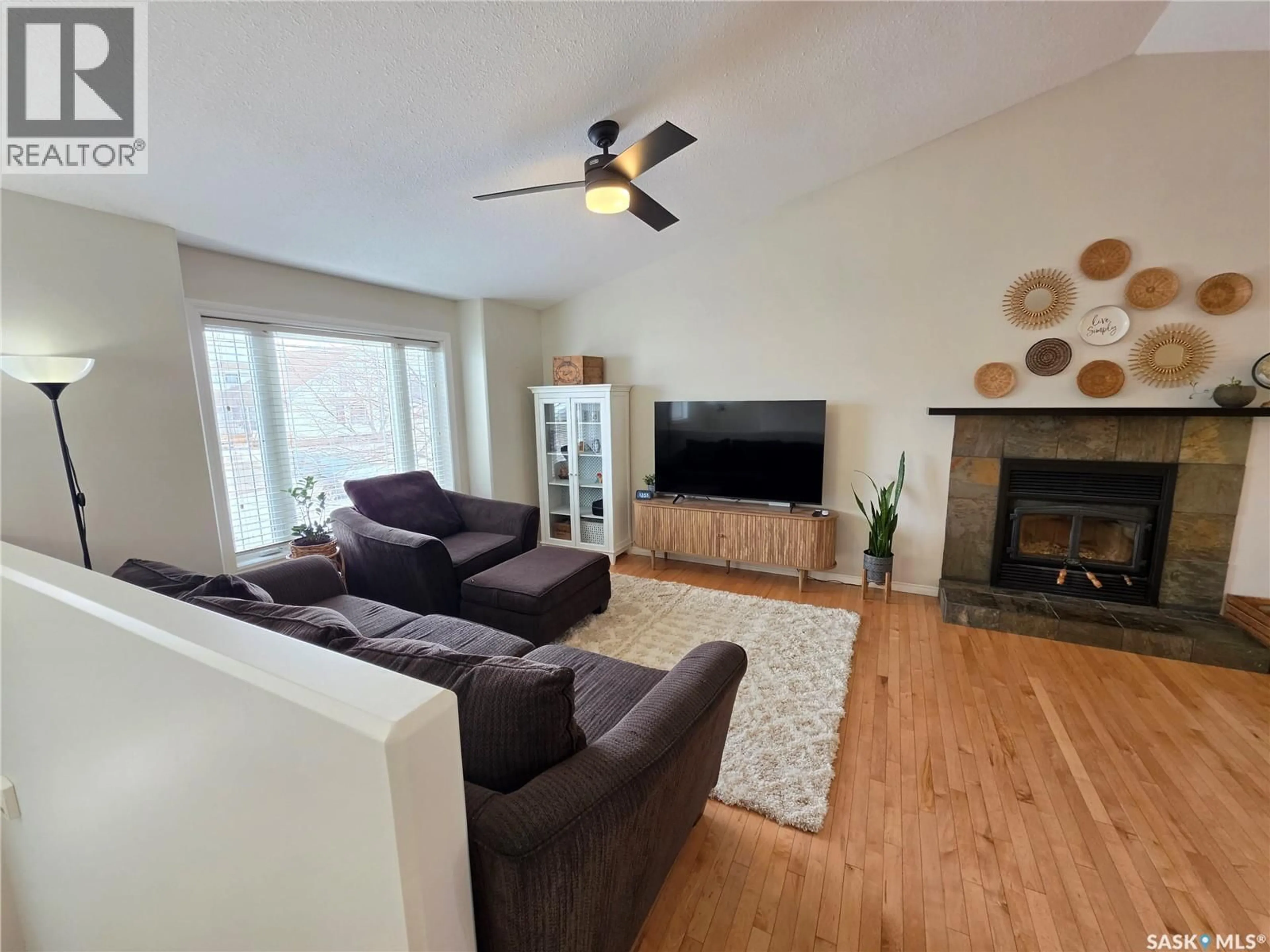 Living room with furniture, wood/laminate floor for 701 7TH AVENUE, Meadow Lake Saskatchewan S9X1A7