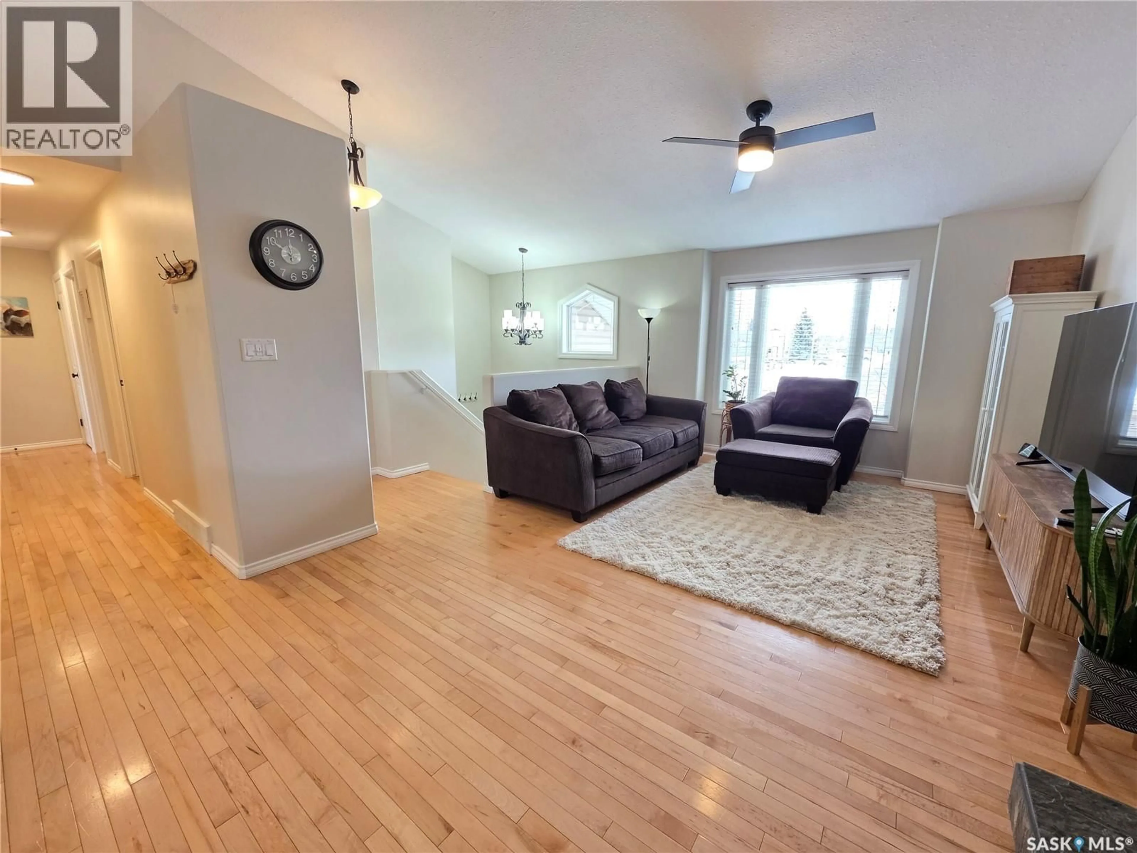 Living room with furniture, wood/laminate floor for 701 7TH AVENUE, Meadow Lake Saskatchewan S9X1A7