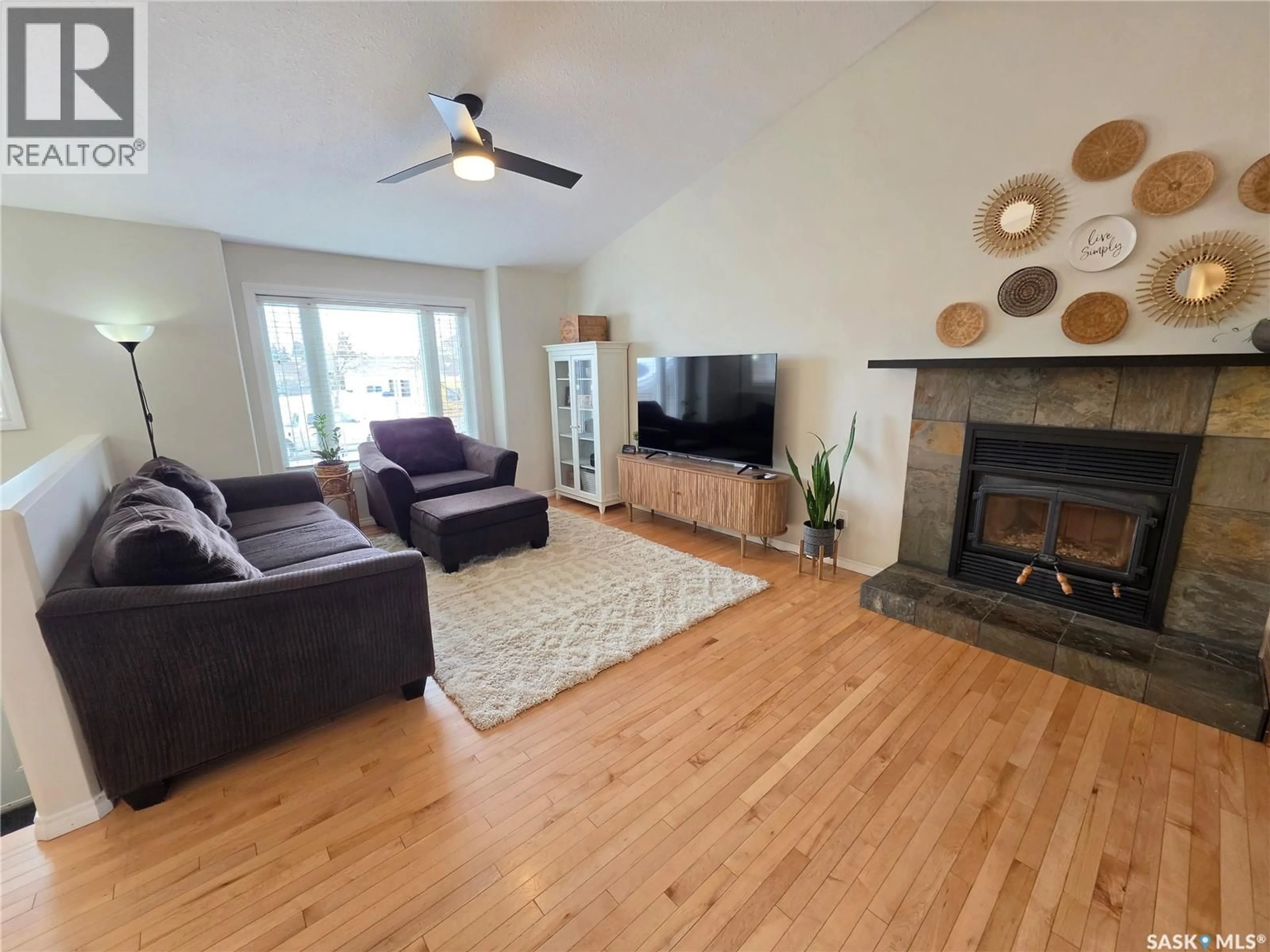 Living room with furniture, wood/laminate floor for 701 7TH AVENUE, Meadow Lake Saskatchewan S9X1A7