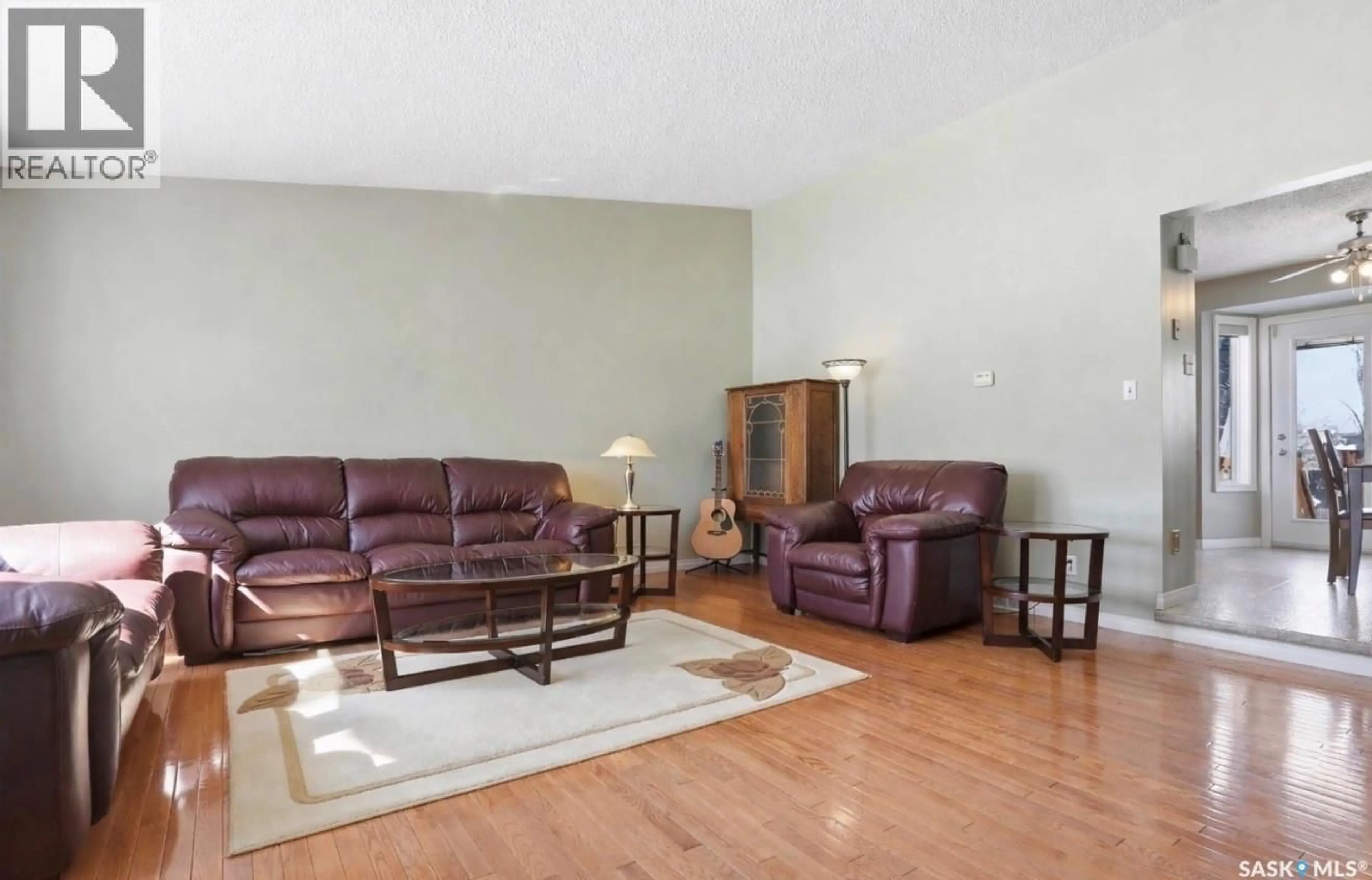 Living room with furniture, wood/laminate floor for 403 BRONSON CRESCENT, Saskatoon Saskatchewan S7J5E2