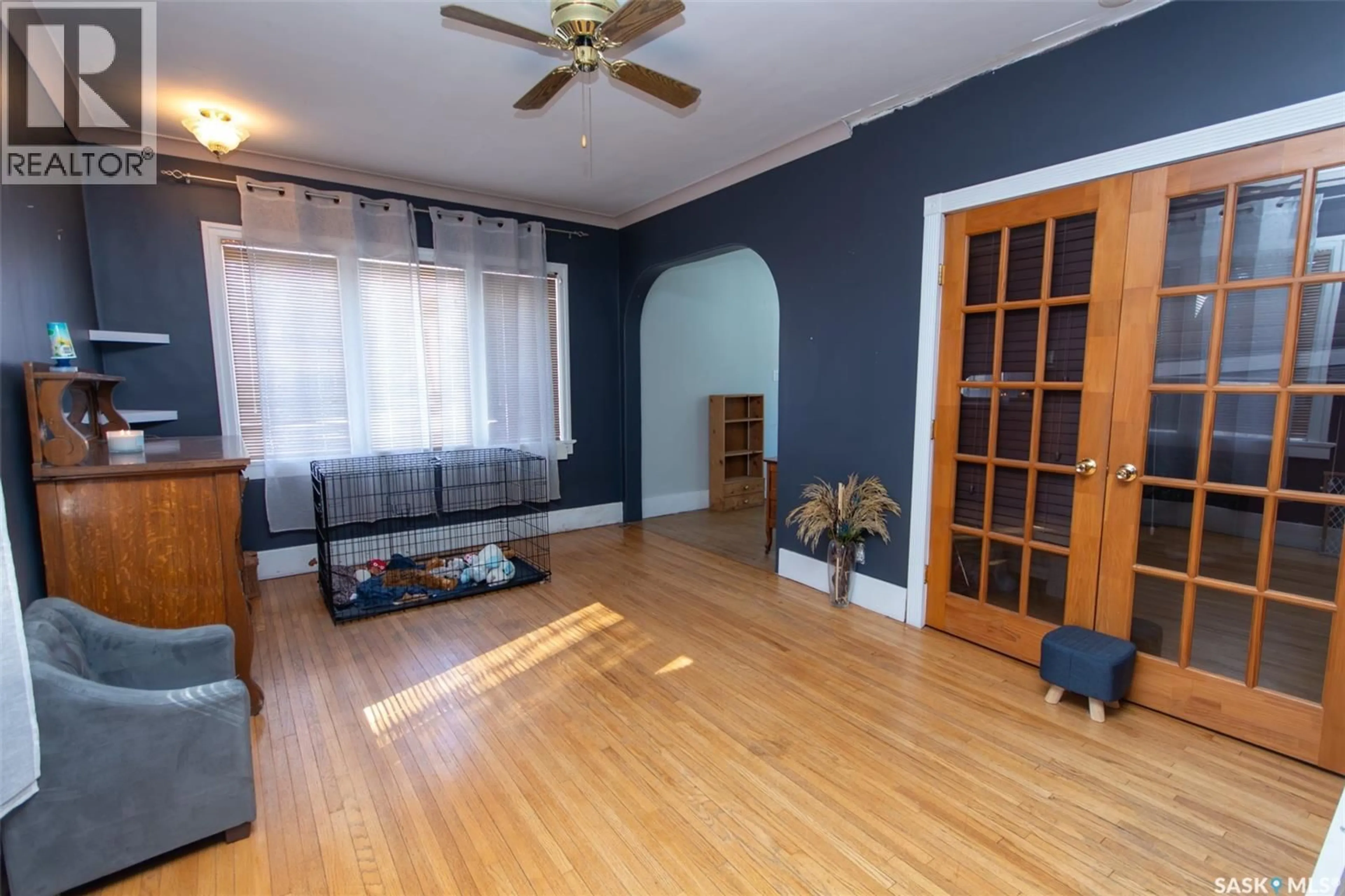 Living room with furniture, wood/laminate floor for 1322 96TH STREET, North Battleford Saskatchewan S9A0H4