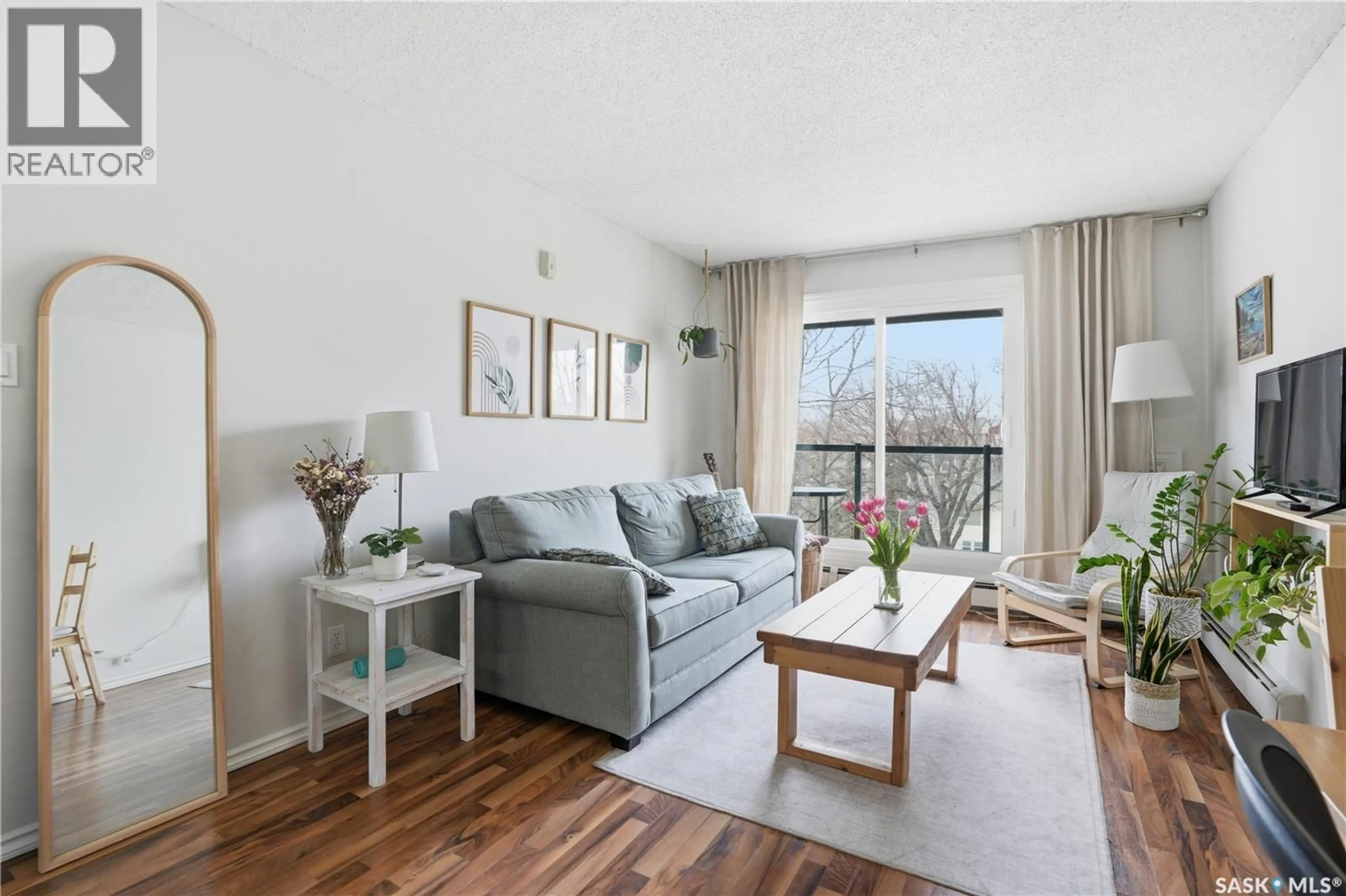 Living room with furniture, wood/laminate floor for 403 1013 LANSDOWNE AVENUE, Saskatoon Saskatchewan S7H2C2