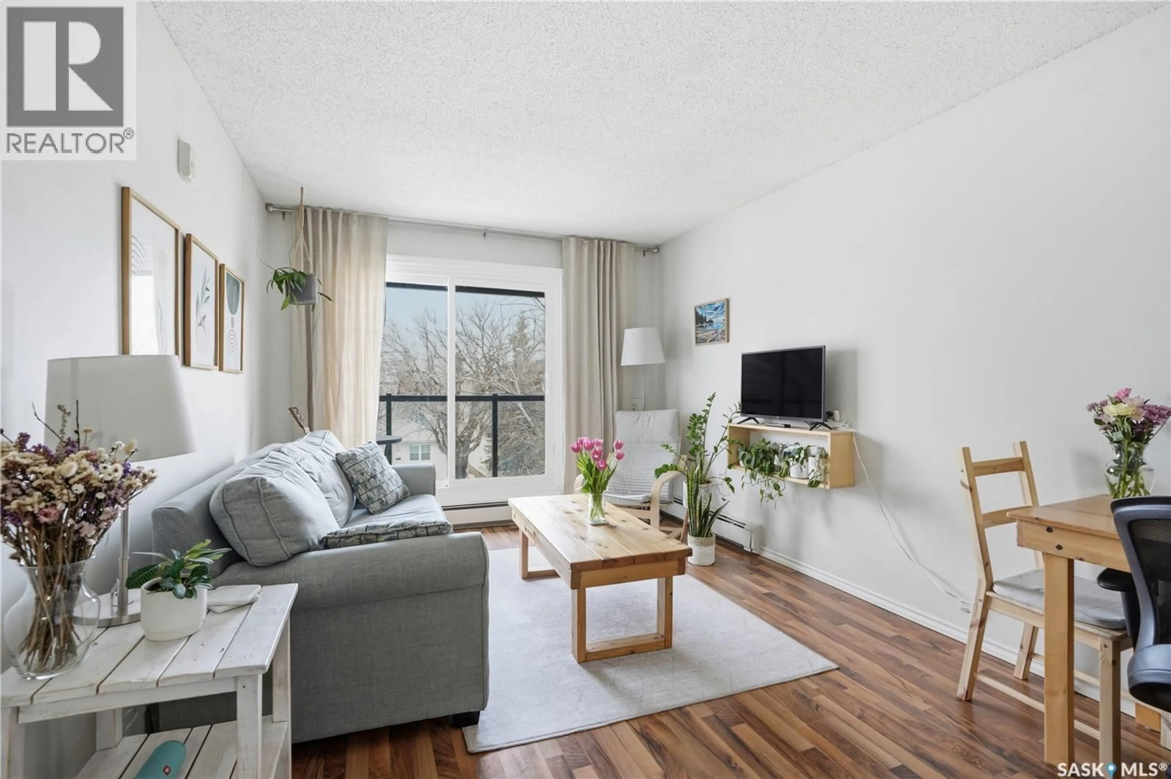 Living room with furniture, wood/laminate floor for 403 1013 LANSDOWNE AVENUE, Saskatoon Saskatchewan S7H2C2